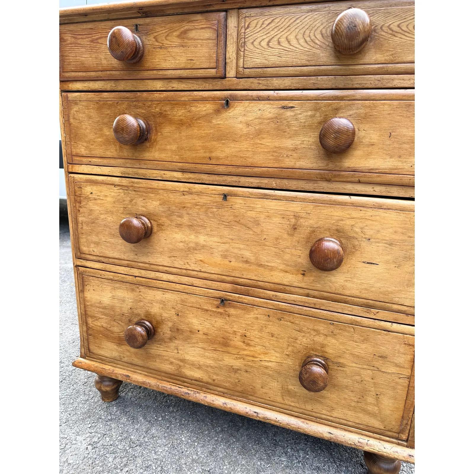 This is a lovely antique pine chest! This piece dates to the 19th century and has lovely patina. The wood has a warm glow, that is accented perfectly by the darker stained knobs. This chest is two over three design with a rustic feel. This chest