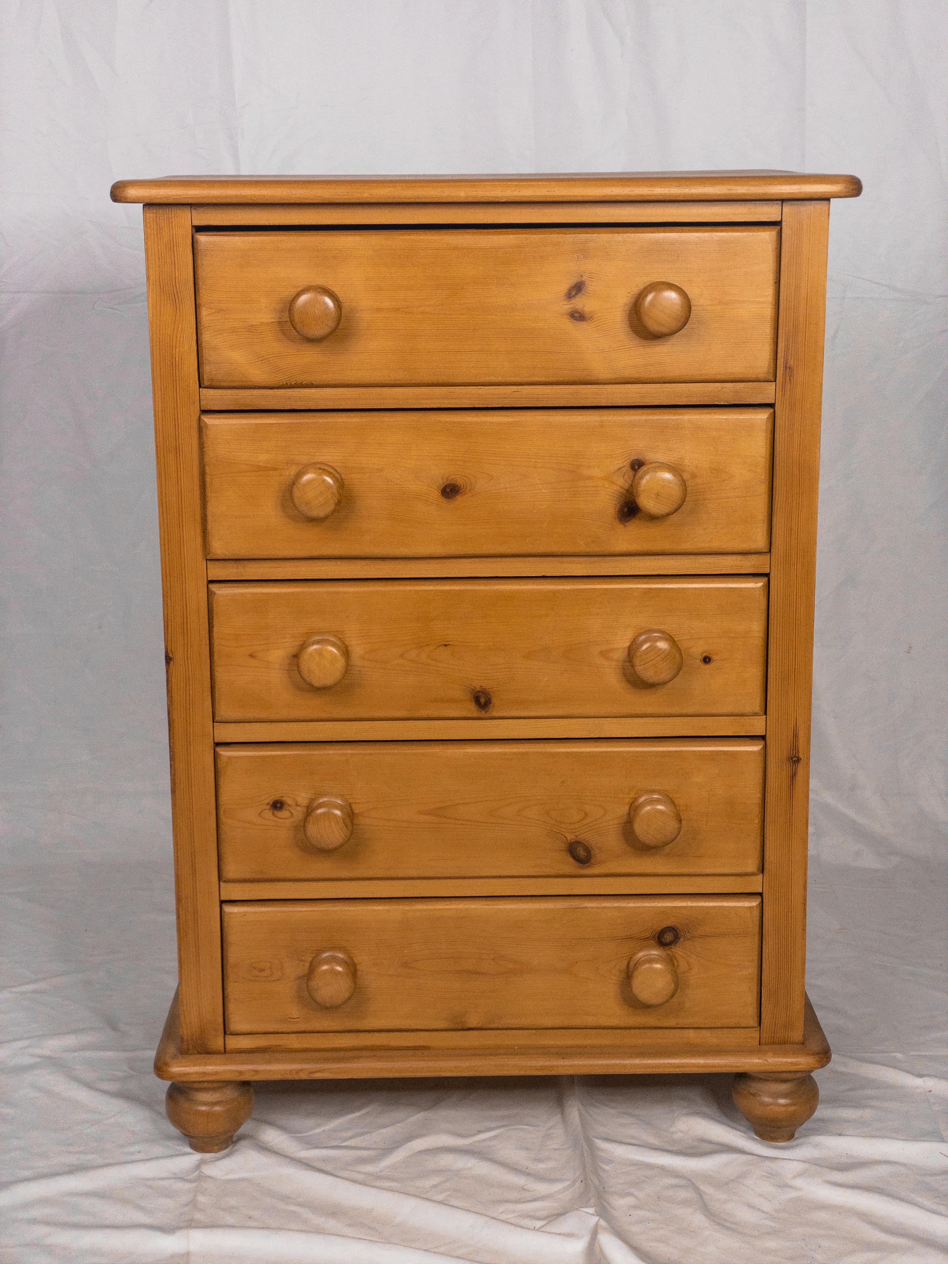 The 19th Century English Pine Chest of Drawers is a remarkable antique furniture piece that captures the essence of a bygone era. Crafted from solid pine wood, it bears the warm, aged patina that only time can impart, adding to its historical