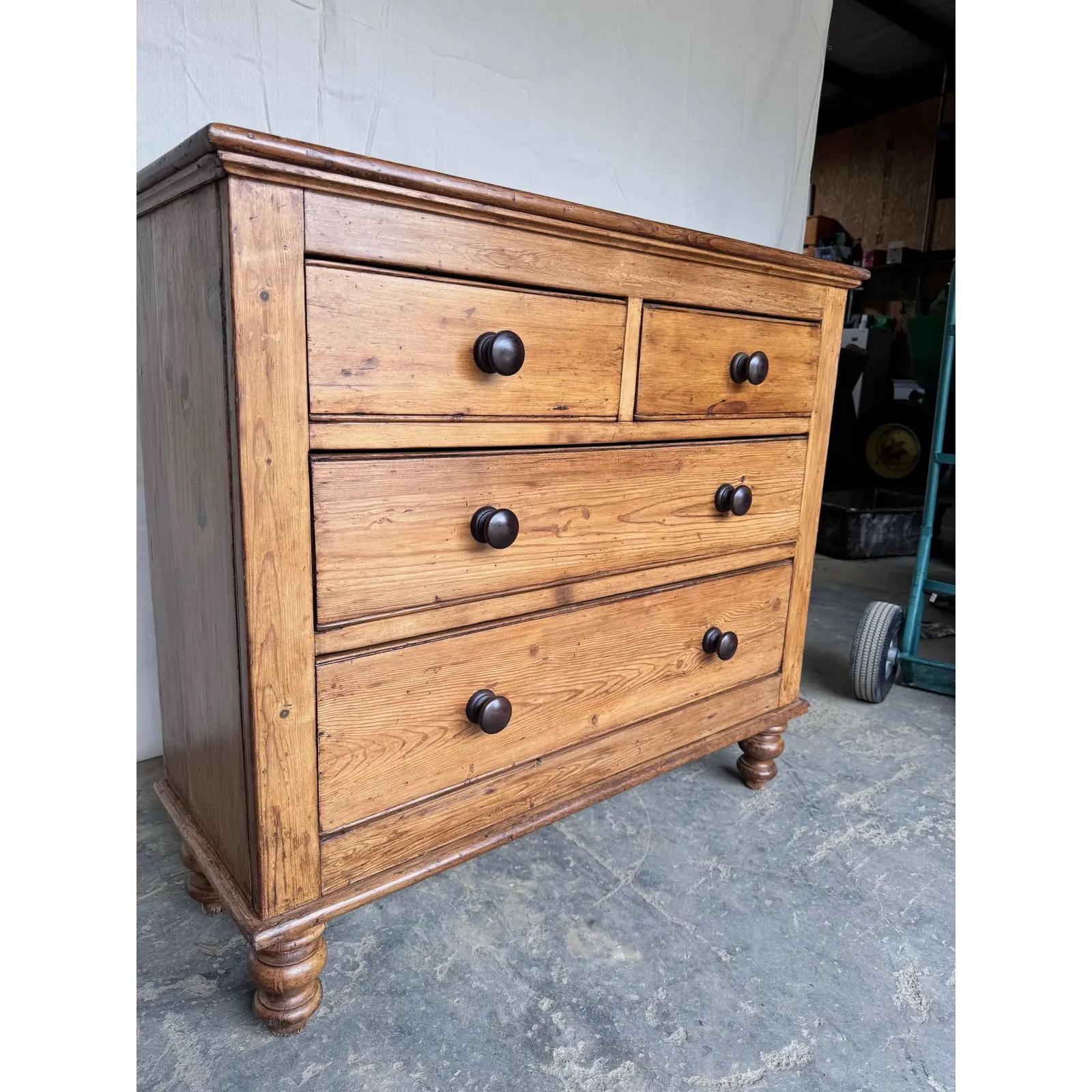 This is a lovely English 2 over 2 pine chest! This piece dates to the 19th century and has lovely patina. The wood has a warm glow, that is accented perfectly by the darker stained knobs. Being a two over three design with a casual simple feel. This