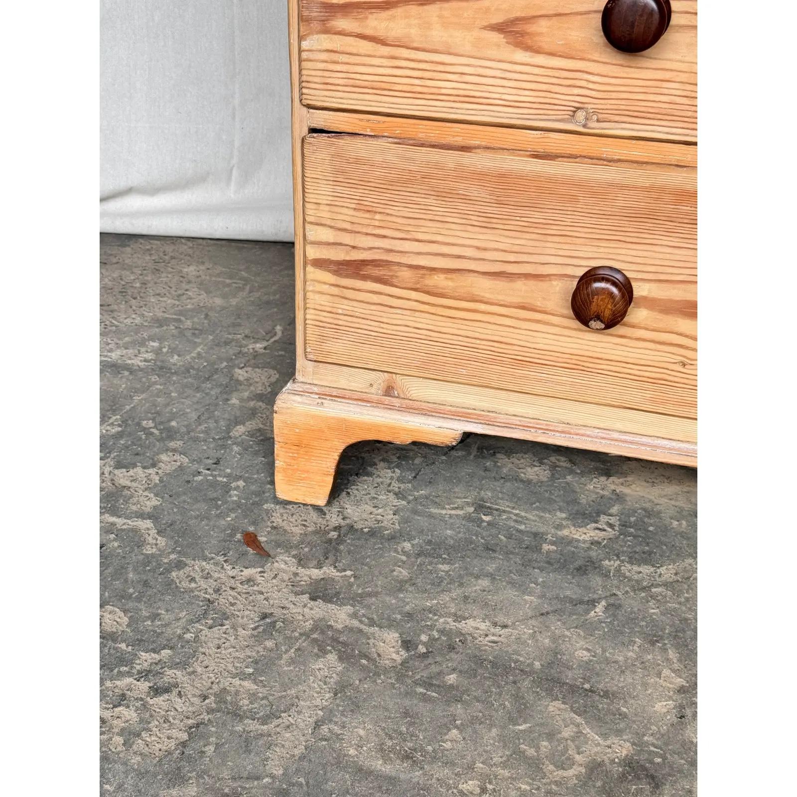 This is a lovely English 2 over 2 pine chest! This piece dates to the 19th century and has lovely patina. The wood has a warm glow, that is accented perfectly by the darker stained knobs. Being a two over three design with a casual simple feel. This