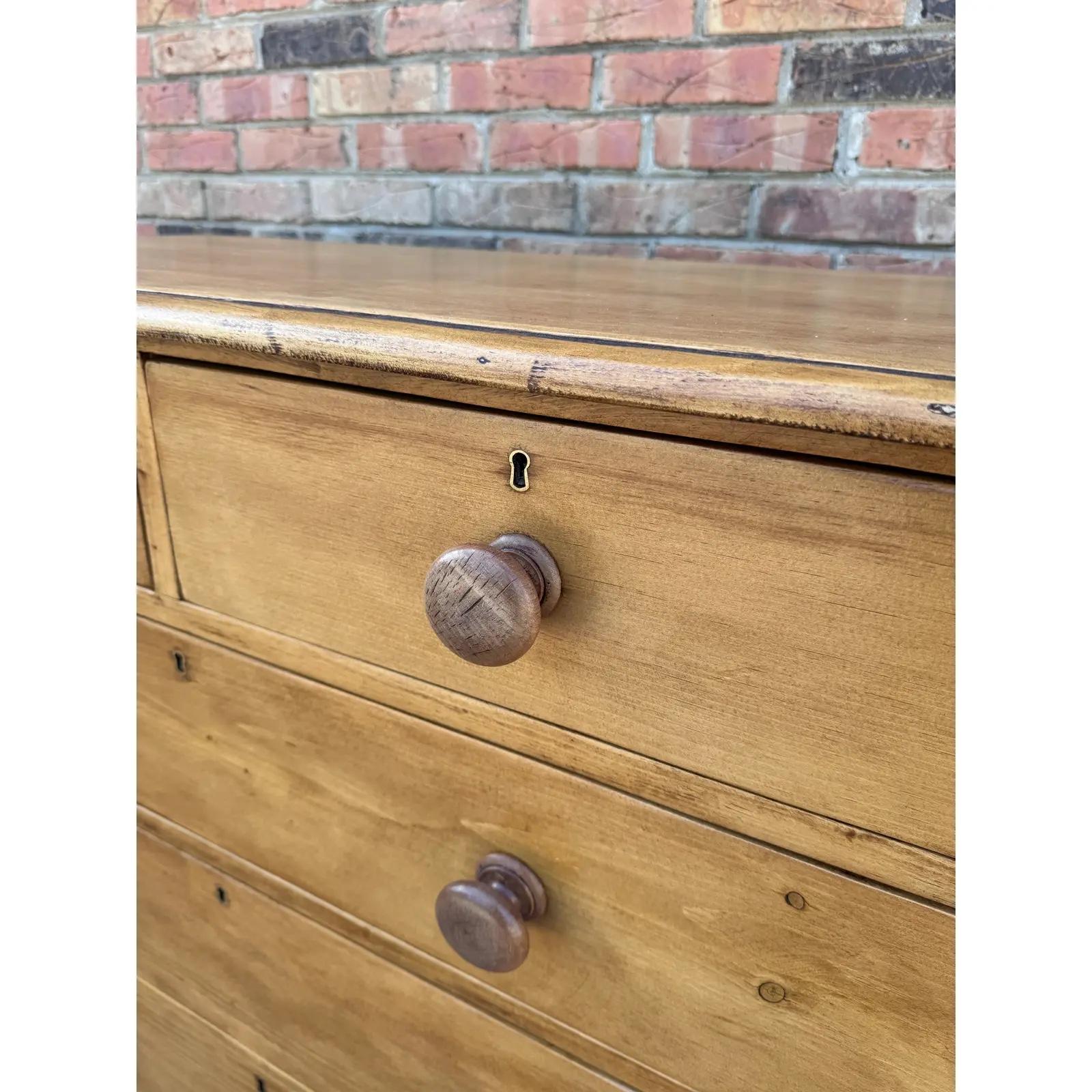 This piece dates to the 19th century and has lovely patina. The wood has a warm glow, that is accented perfectly by the darker stained knobs. Being a two over three design with a casual simple feel. This chest would make an excellent addition to a