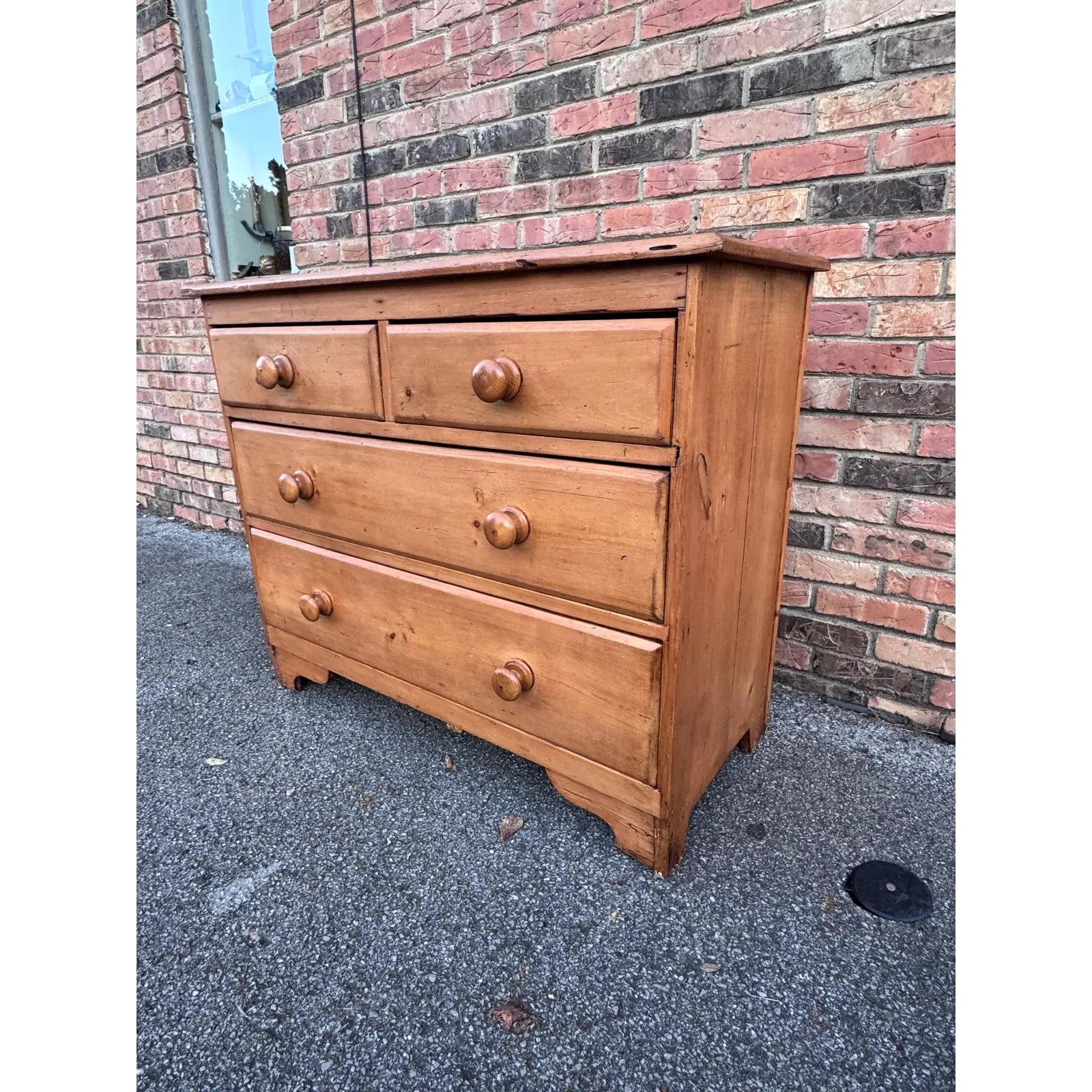 This is a lovely antique pine chest! This piece dates to the 19th century and has lovely patina. The wood has a warm glow, that is accented perfectly by the darker stained knobs. Being a two over two design with a casual simple feel. This chest