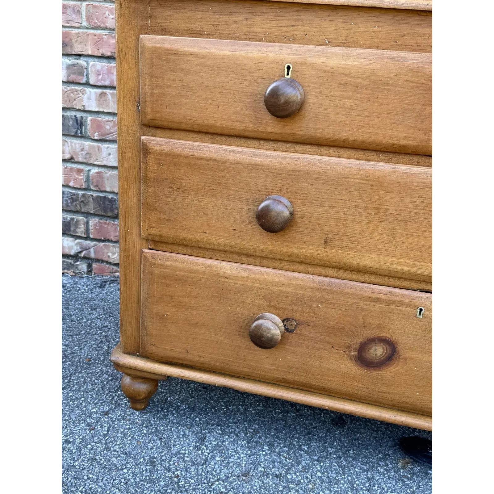 This is a lovely antique pine chest! This piece dates to the 19th century and has lovely patina. The wood has a warm glow, that is accented perfectly by the darker stained knobs. Being a two over two design with a casual simple feel. This chest