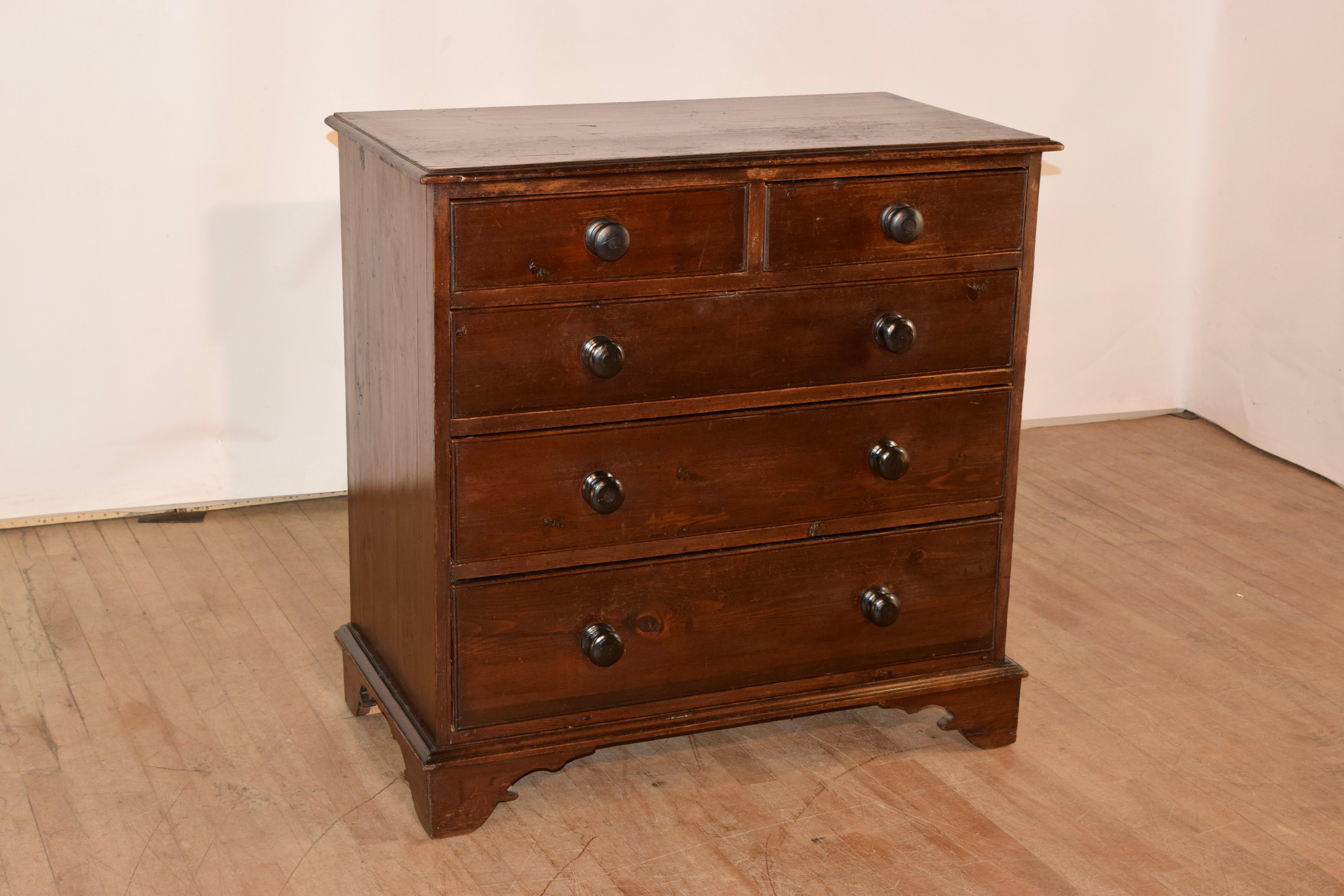 19th century pine chest form England. The top has a beveled edge, following down to two over three drawers. The sides are simple and the piece is raised on bracket feet.