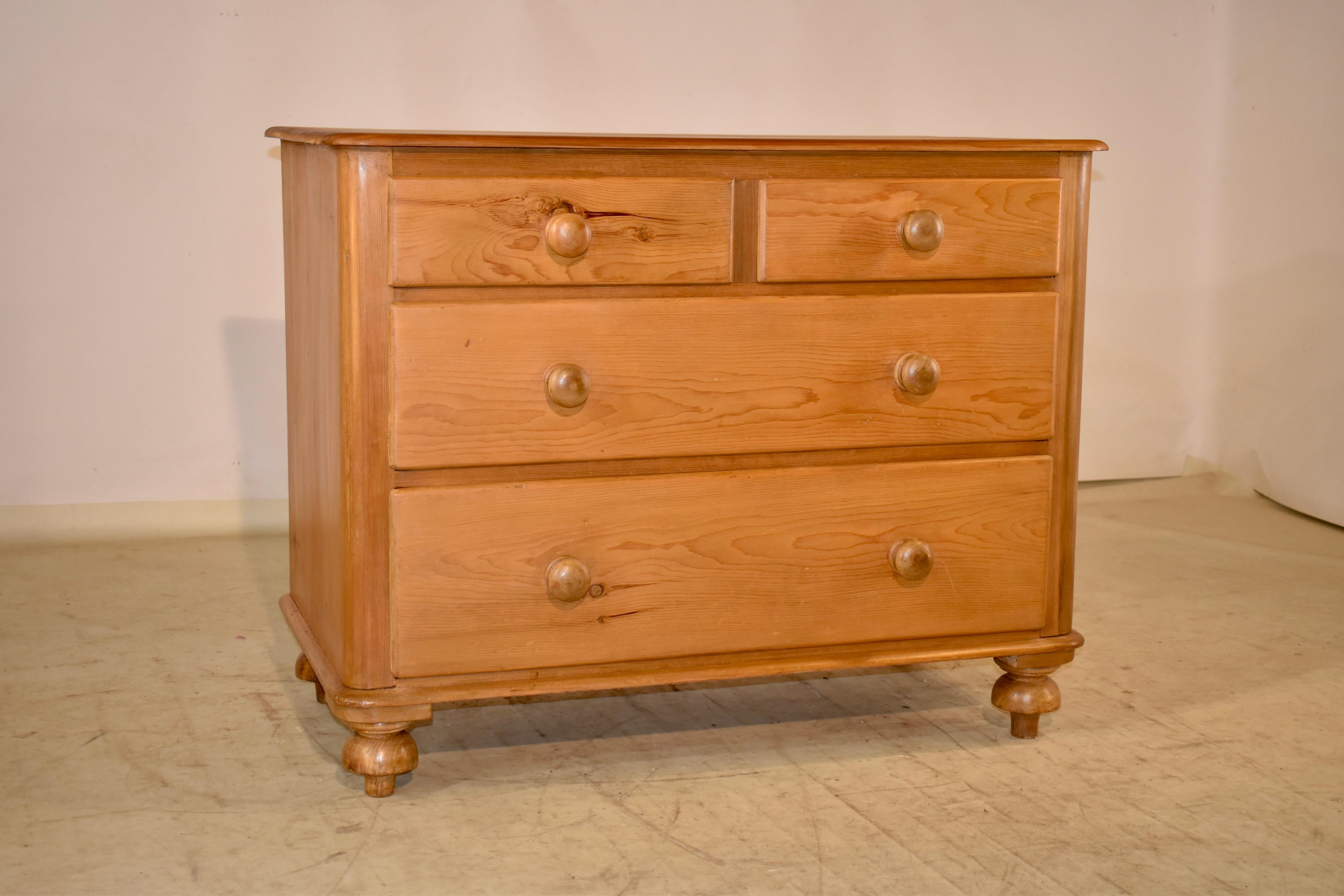 19th century pine chest of drawers from England. The top is made from two boards, and follows down to simple sides. The case has two smaller drawers over two larger drawers and has a molded base. The piece is supported on hand turned feet.