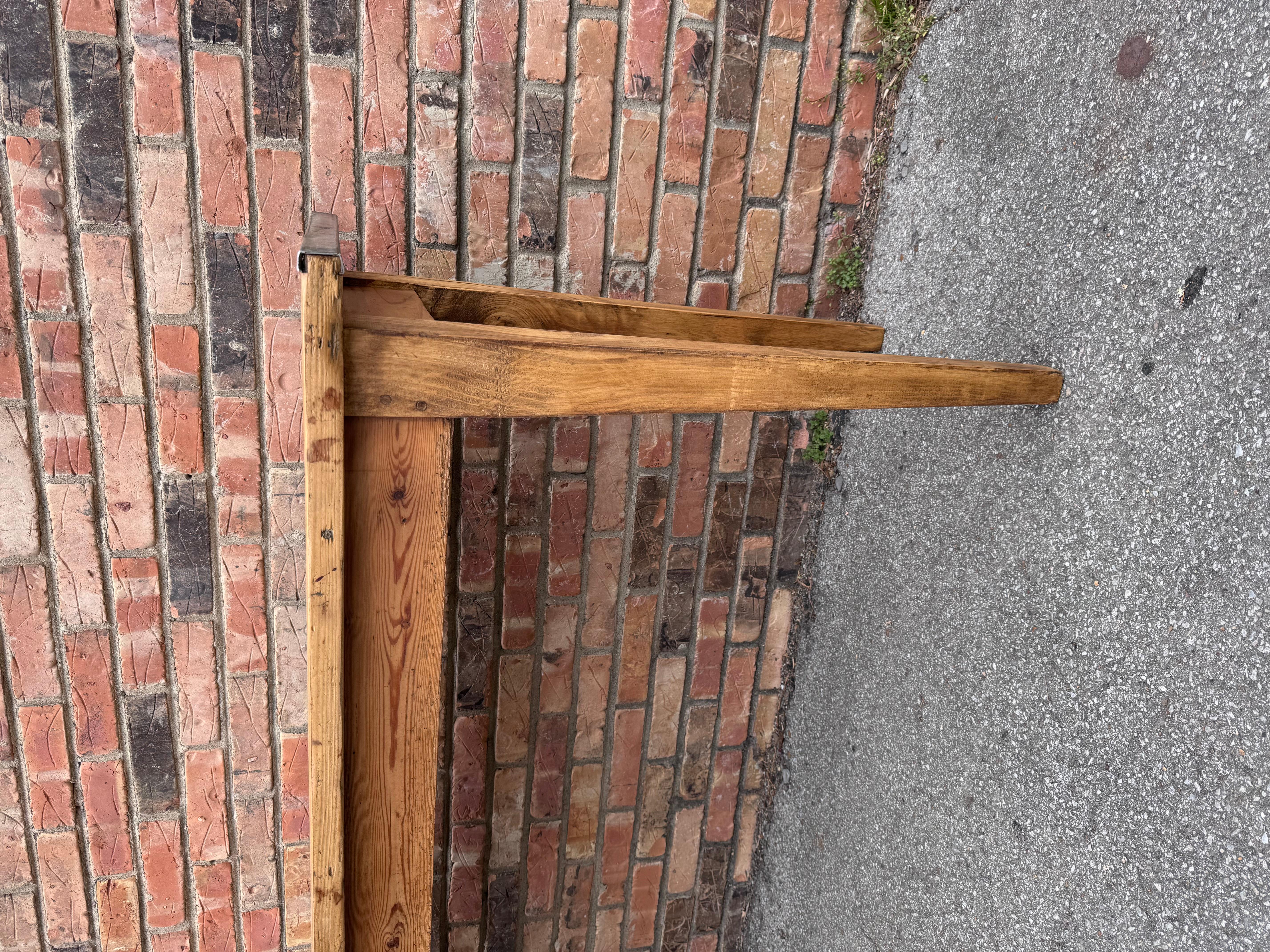 This is an antique pine console out of France, Resting on tapered legs the pine shows nice age and patina each end is capped with metal which adds to the uniqueness.