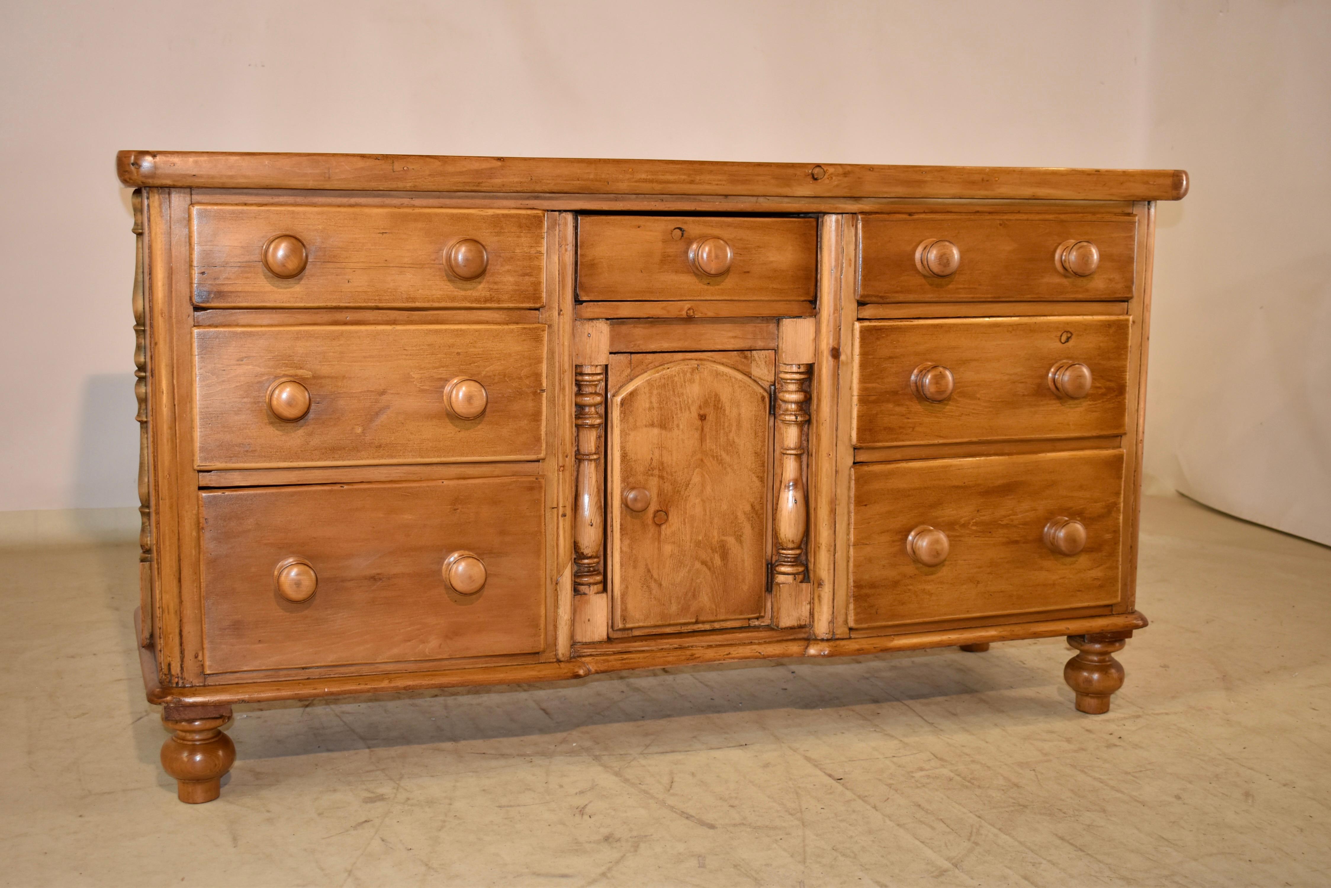 19th century pine dresser base from England.  The top is 1.75 inches thick, which is an amazing feature for this dresser base!  The top follows down to simple sides, both with applied moldings for added design interest.  The from of the case has two
