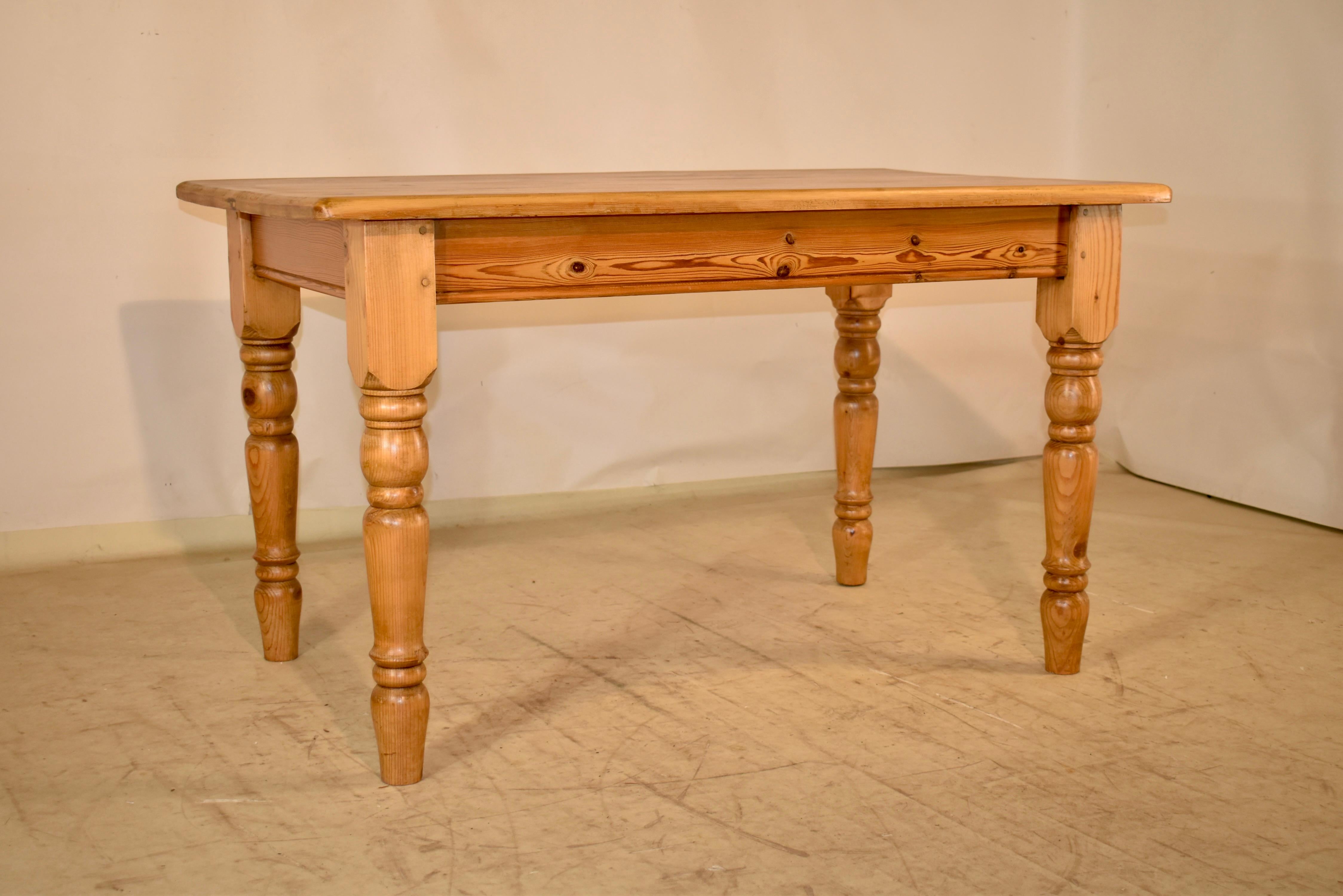 19th century pine farm table from England.  The top is made up from planks and have a lovely color and graining, in addition to the great knotting, which is a charming addition to the table.  The apron is simple and measures 25.25 inches in height. 