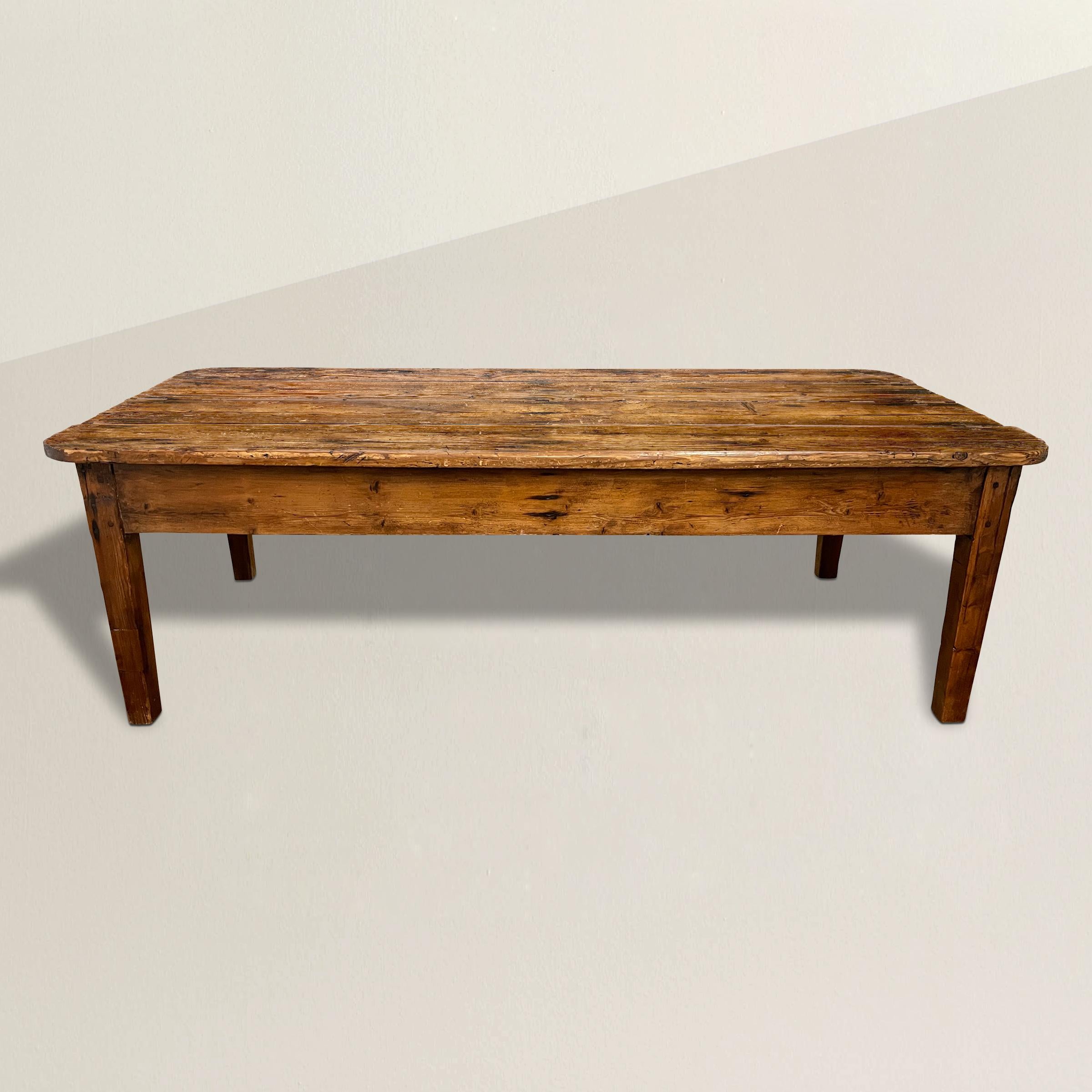 A perfect charming 19th century English pine low table with a top with four pine planks with rounded corners and the most wonderful patina, raised on a rectangular base with square tapered legs. Perfect in any country home, but also right at home