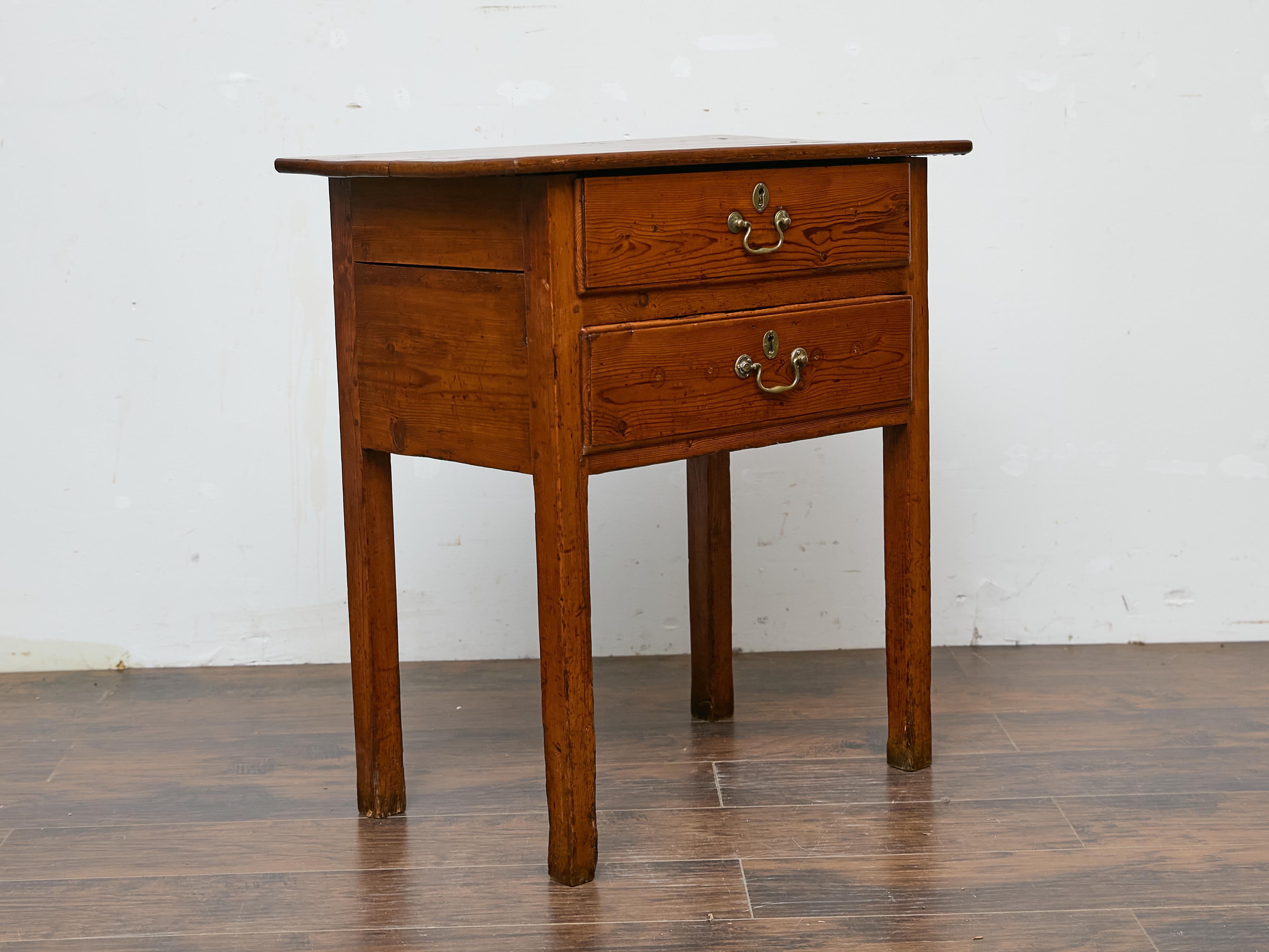 This 19th-century English pine table captures the warmth of aged wood with its beautifully worn patina and time-softened edges. The simple, functional design features a rectangular top with a slightly overhung edge, resting on straight, slightly