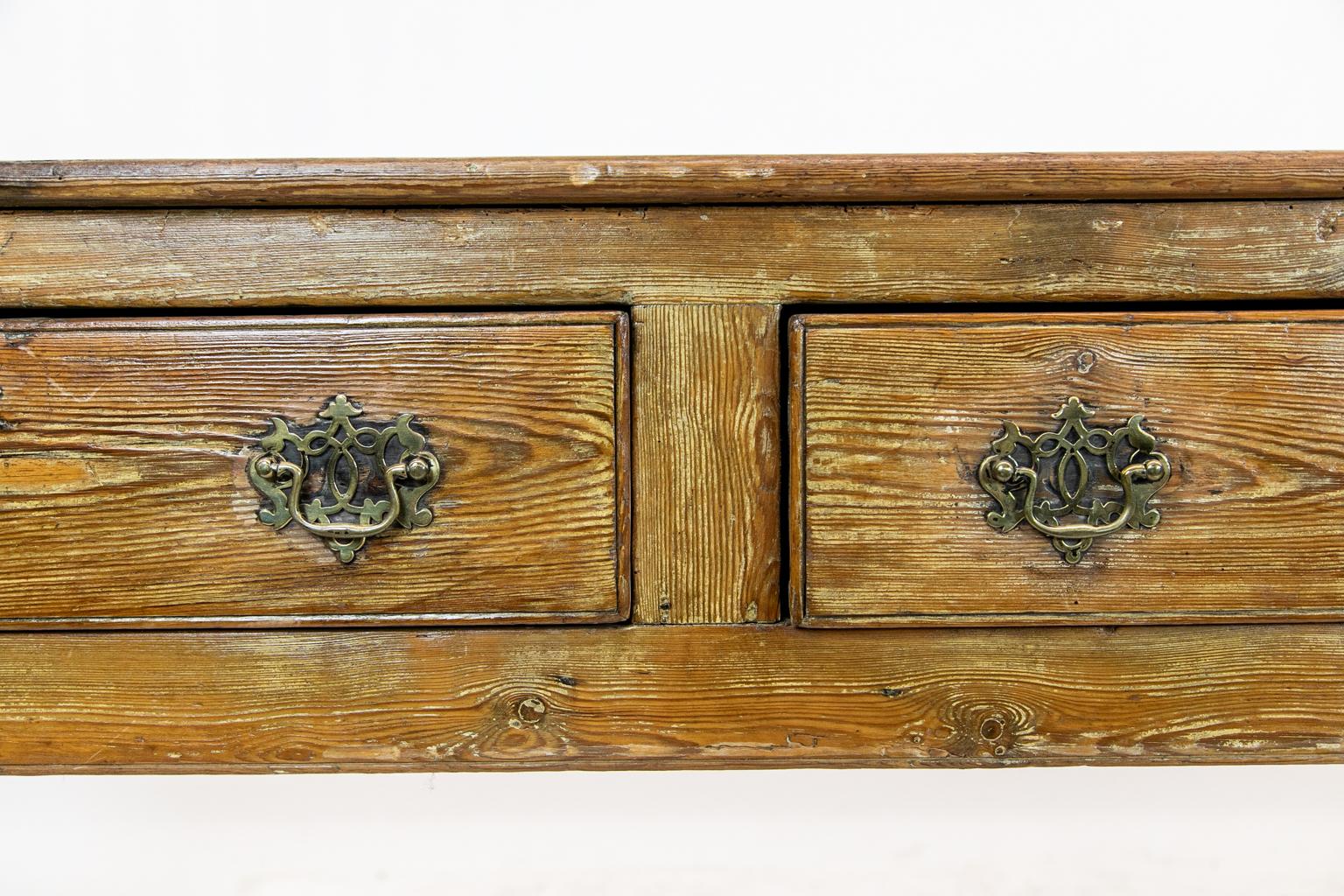19th century English pine sideboard with three incised cockbeaded drawers and open trellis pulls and escutcheons. There is a bullnosed molded top and a carved plate groove at the back of the top.