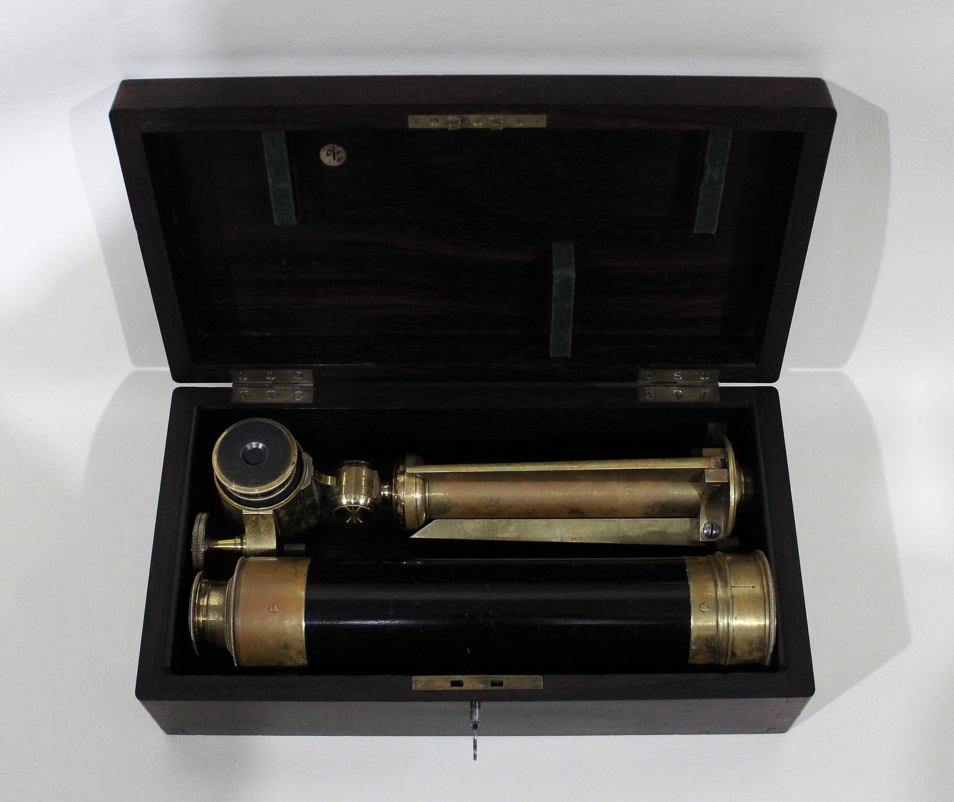 A four draw brass and mahogany telescope with mount/tripod feature and secondary eyepiece. In fitted lockable wood case with built in handle for portability. Sliding eyepiece cover is functioning and has a removable lens cap. No visible maker's
