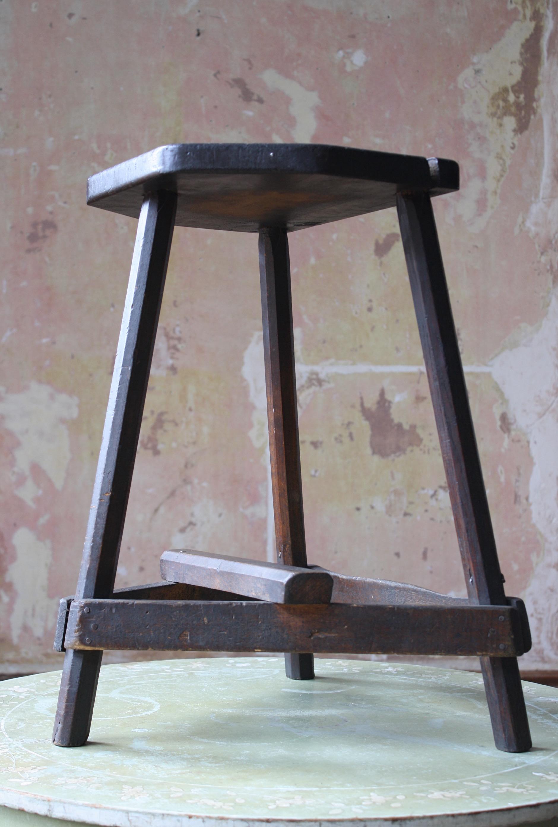 A perfectly worn and better than your average cricket stool, with chamfered legs, a thick seat and planked supports. 

Lots of period repairs, marks and abrasions. The stool is perfectly sturdy and is very much still fit for purpose, with a