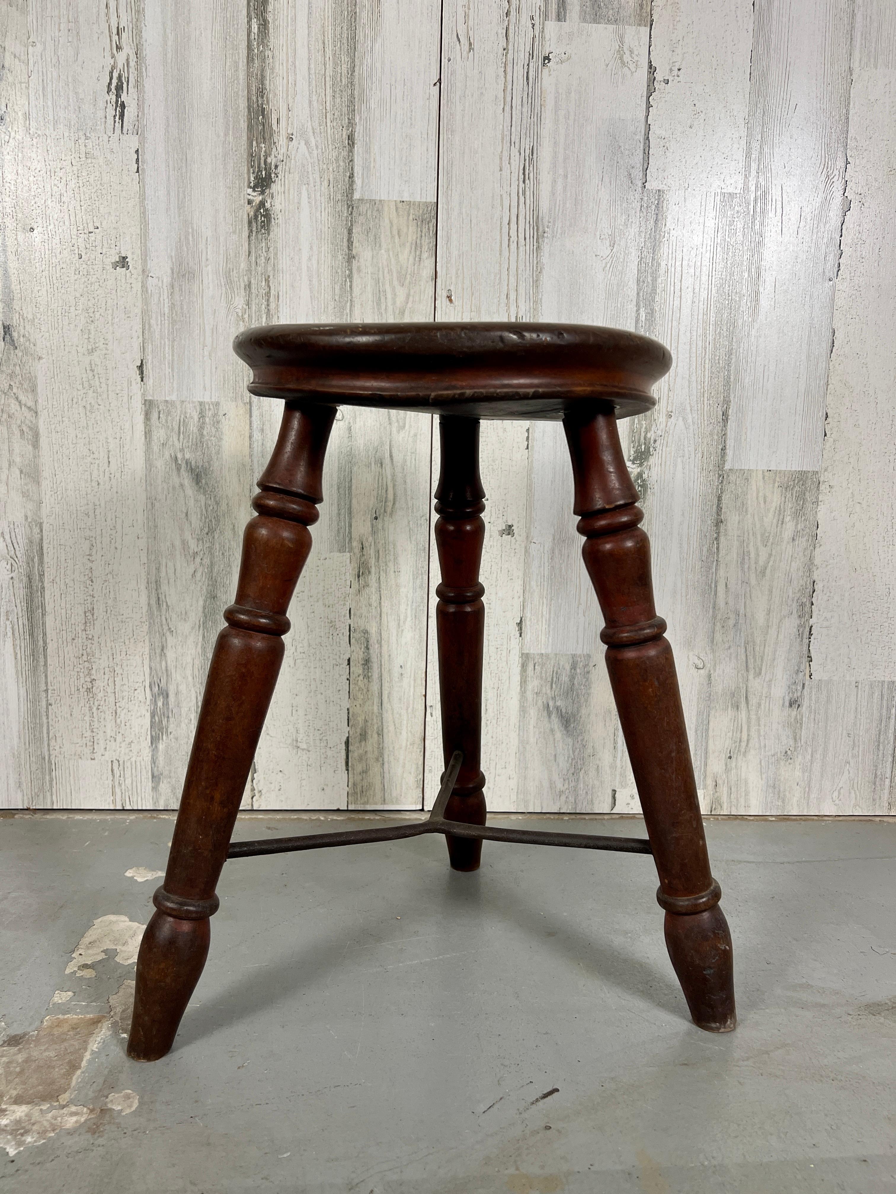 Handcrafted solid elm tripod stool with iron stretcher from an English pub.