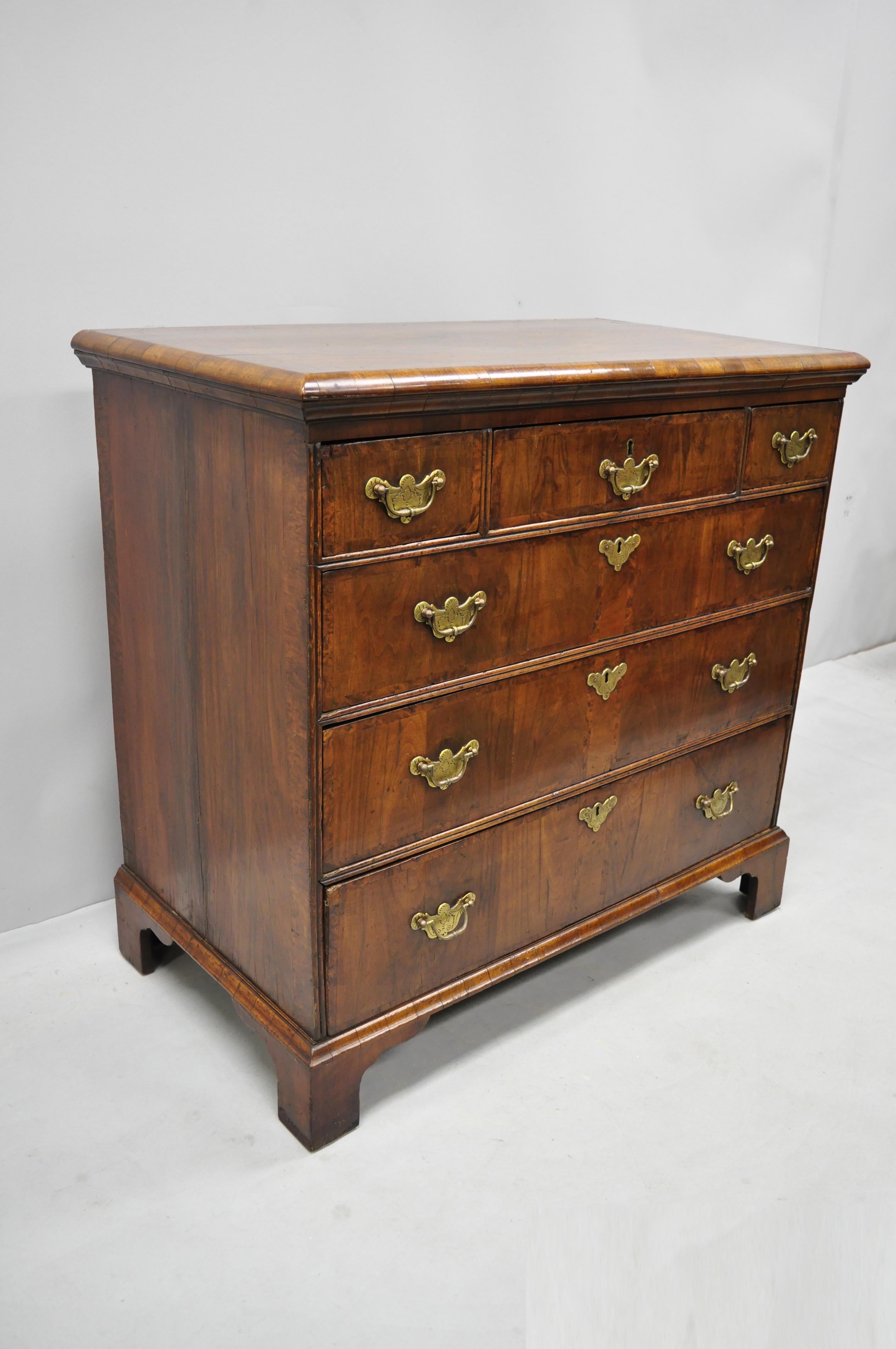 19th century English Queen Anne burr walnut inlaid 6-drawer chest. Item features beautiful wood grain, original distressed finish and patina, original label, no key but unlocked, 6 dovetailed drawers, solid brass hardware, nice inlay, quality