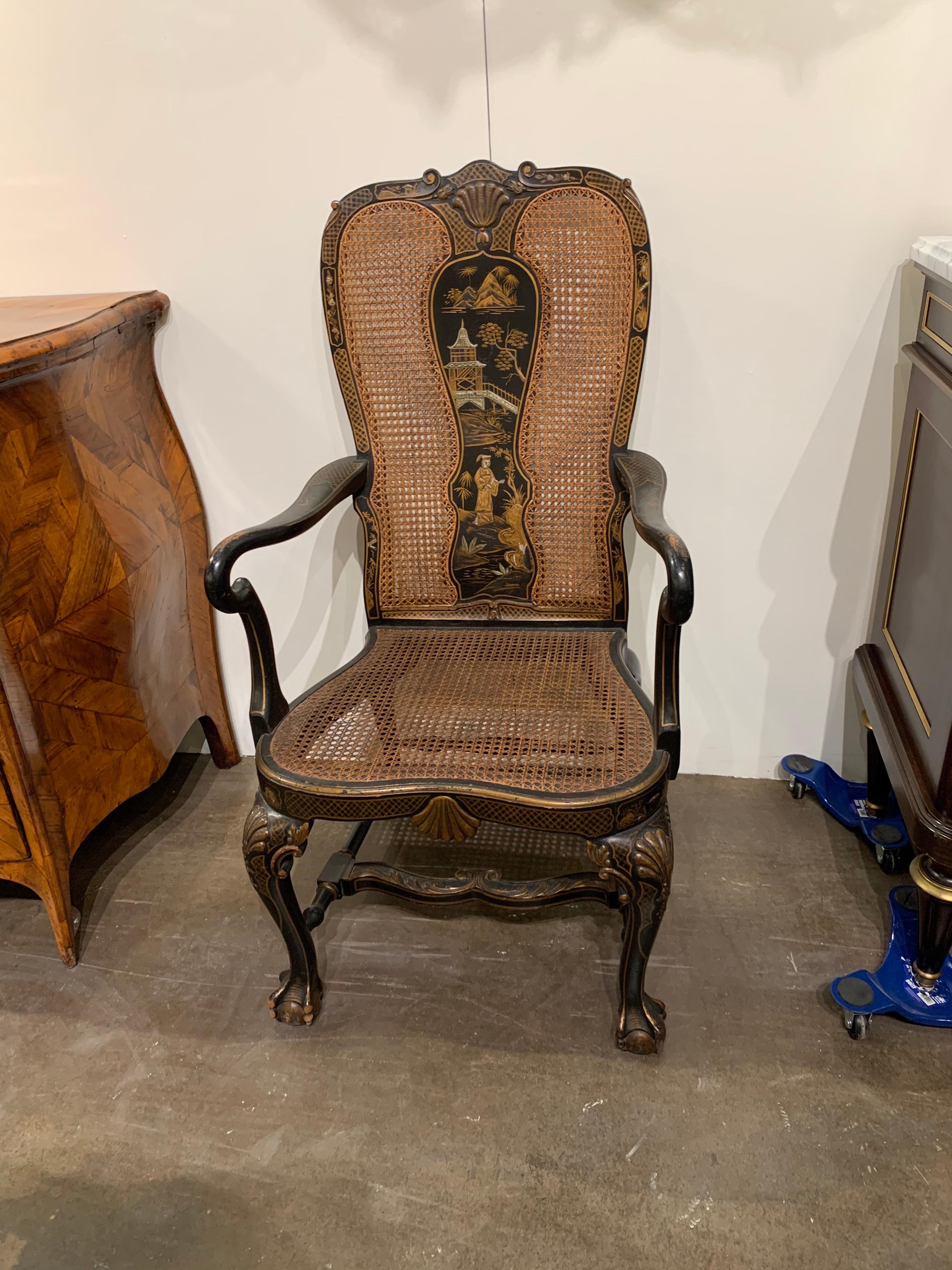 Fabulous 19th century English Queen Anne chinoiserie high back armchair. Nice hand painted design on the back, arms and legs. There is a small hold in the cane, but the overall stability of the chair is fine. A great decorative piece!