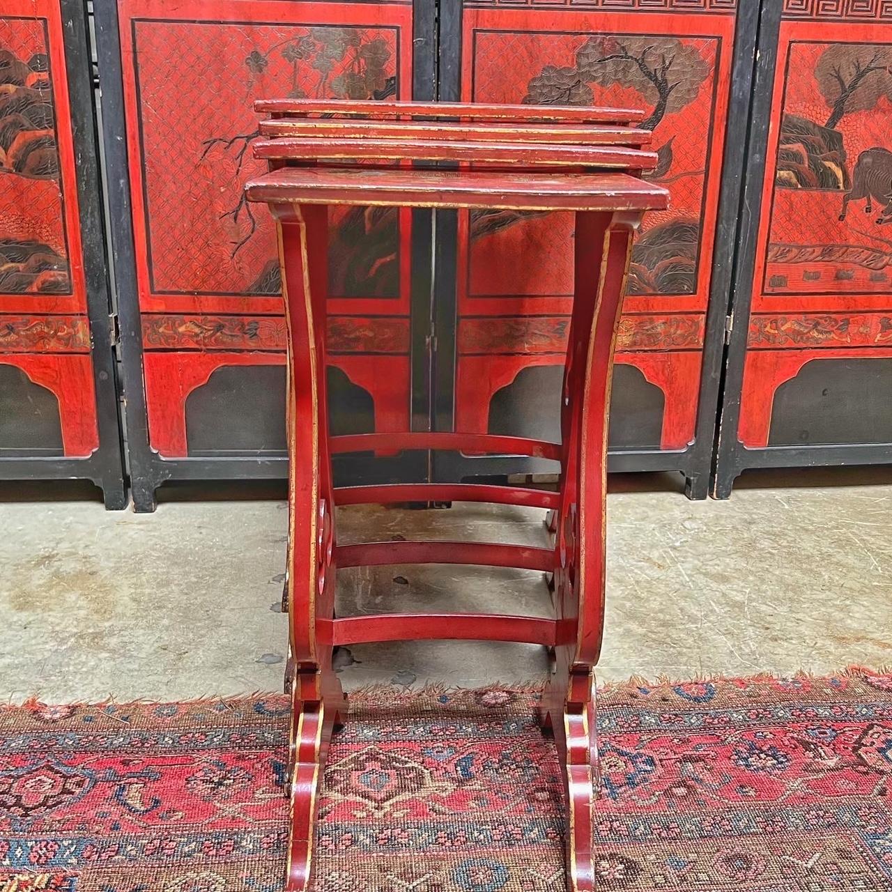 A charming set of four English red lacqured and Japanned -Chinoiserie nesting tables dating from the late 19th century. All four tables are decorated with red crackled lacquer with gilded and painted decoration. They are highly decorative and very
