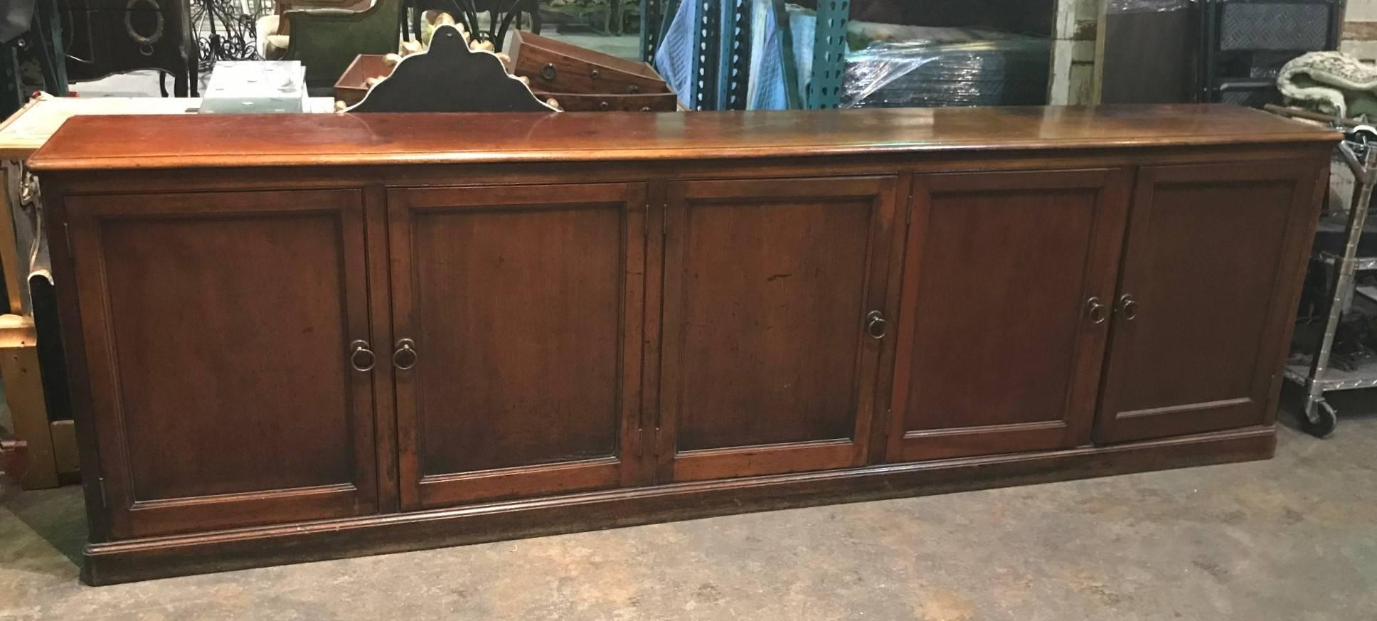 Fabulous 19th century English red mahogany five door credenza with brass ring pulls and wonderfully aged mellow patina,

circa 1890.

Nice long size with narrow depth.