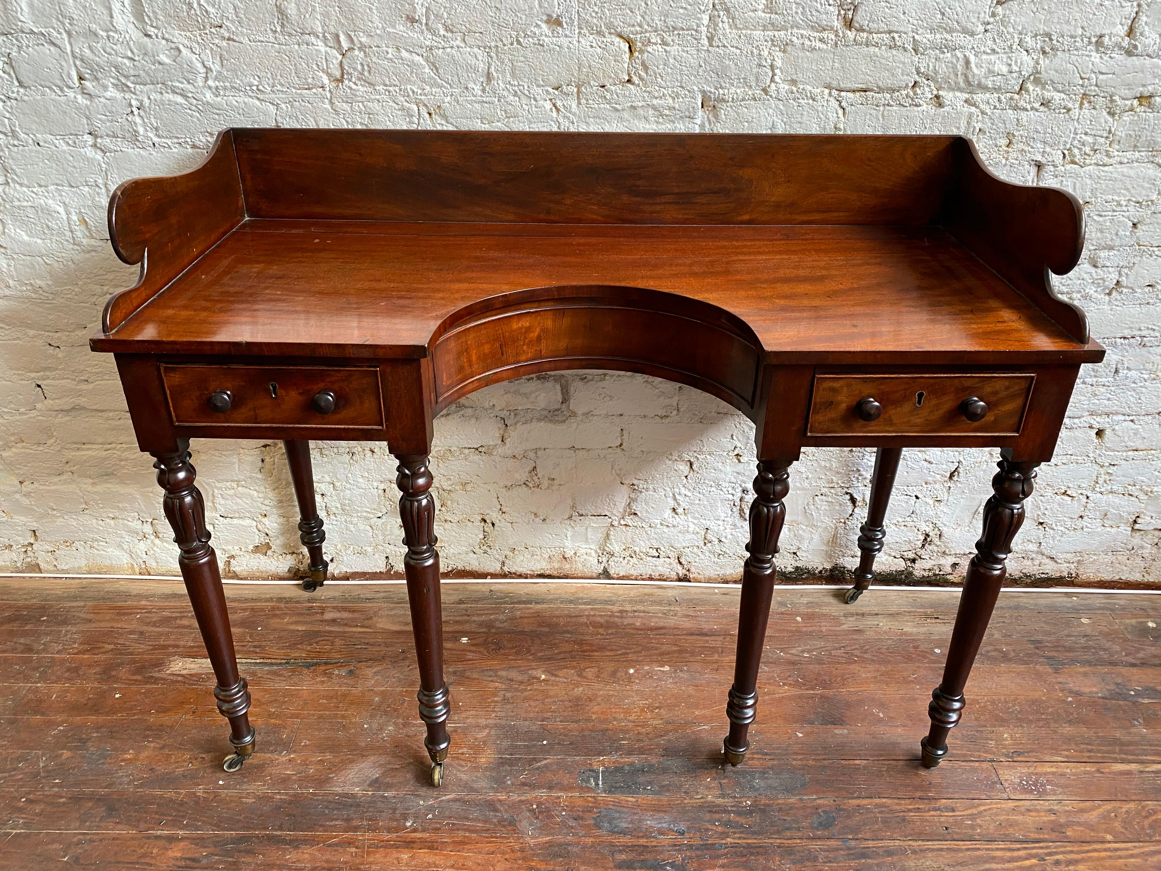 Great size on this 19th century English Regency 6 leg mahogany server. The turned legs have wonderful tulip and lotus carvings and original castors. There are 2 drawers in the frieze and a nice shaped backsplash. The color and patina of the Cuban