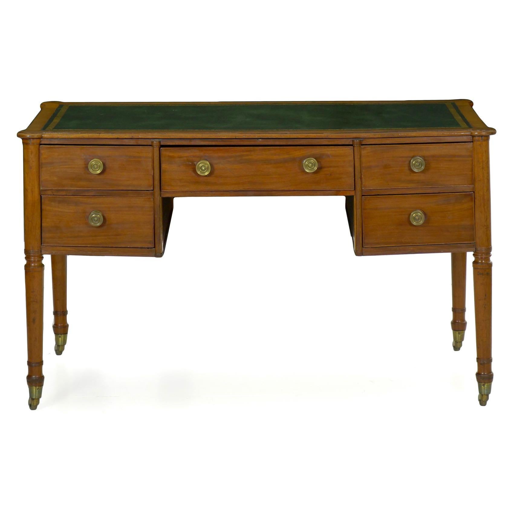 This handsome antique writing desk was at some point the centerpiece of a photograph with Queen Elizabeth signing a photograph or picture. A product from the second quarter of the 19th century, it is crafted in dense mahogany that has faded