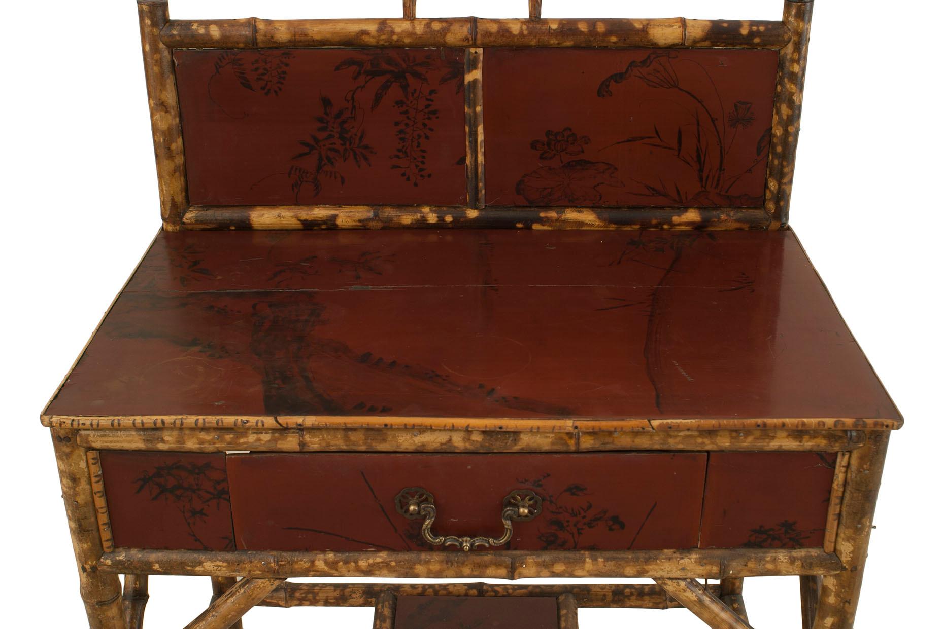 English Regency Style (19/20th century) bamboo and red lacquered small ladies desk with a drawer and a 2-panel back rail with a stretcher.
 