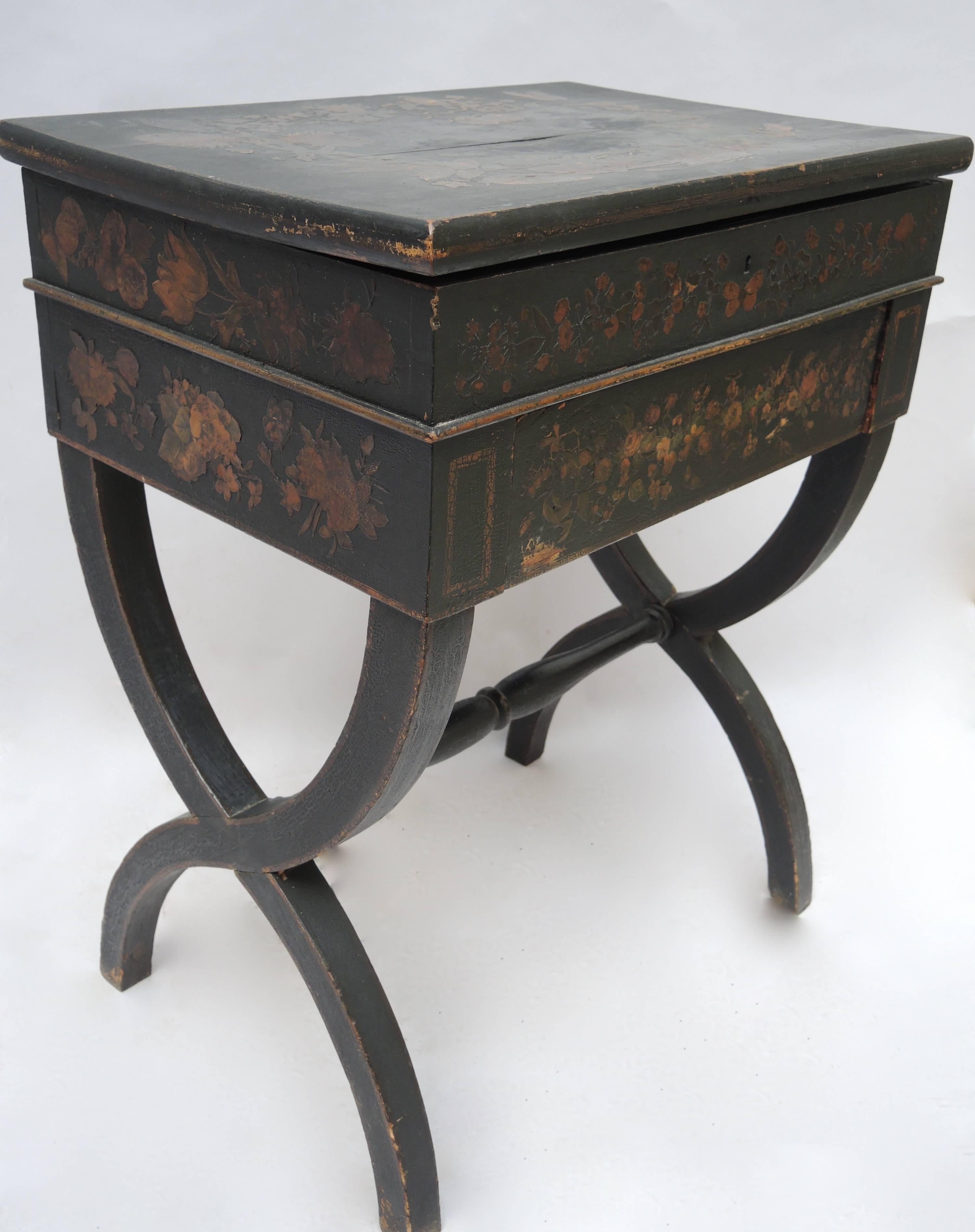 Black English Regency side table or dressing table with applied decoupage decoration of flowers, and insects. The top lifts up to reveal robins egg blue painted interior with two compartments and a mirror. A lovely and versatile table in the