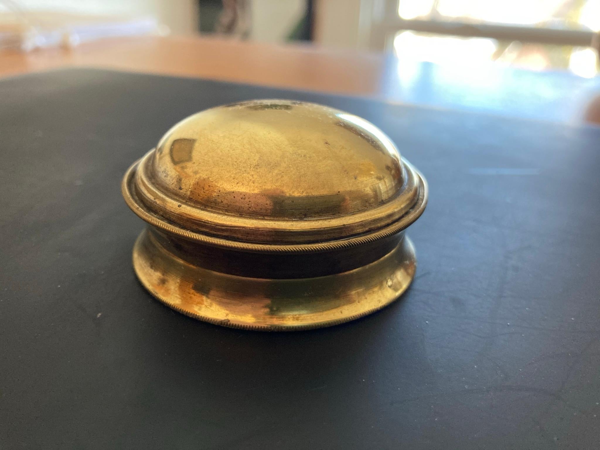 An English brass pocket sundial compass, early 19th century. In a hand turned domed brass case with lovely patina. 

Magnetic dial for latitude 51° North. It has a paper dial card with an outer circle of 32 compass points; North indicated by a
