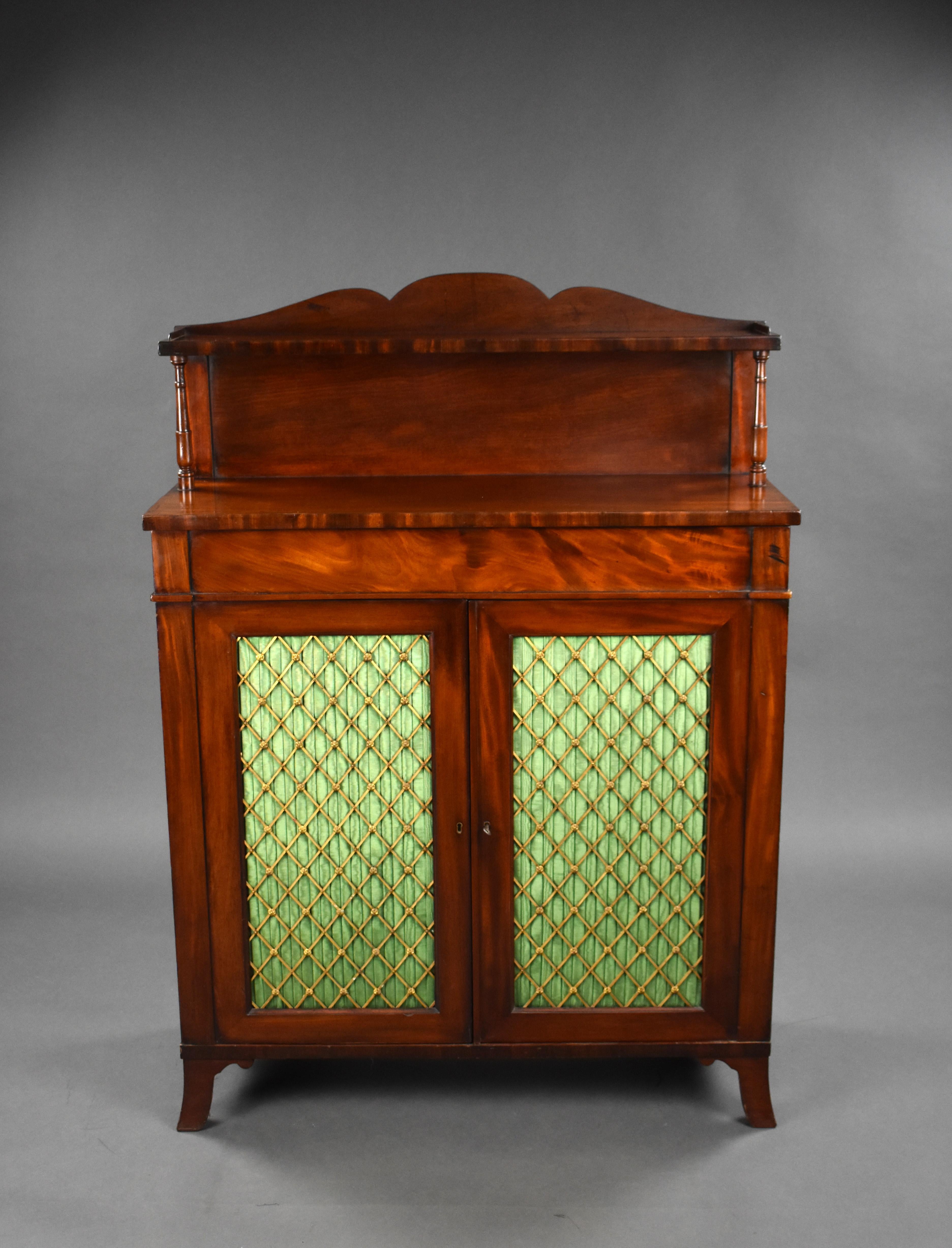 For sale is a good quality Regency mahogany chiffonier, having a shaped back with an open shelf flanked by turned pillars, the projecting base with a single frieze drawer above a pair of rectangular doors with brass grilles lined with pleated silk