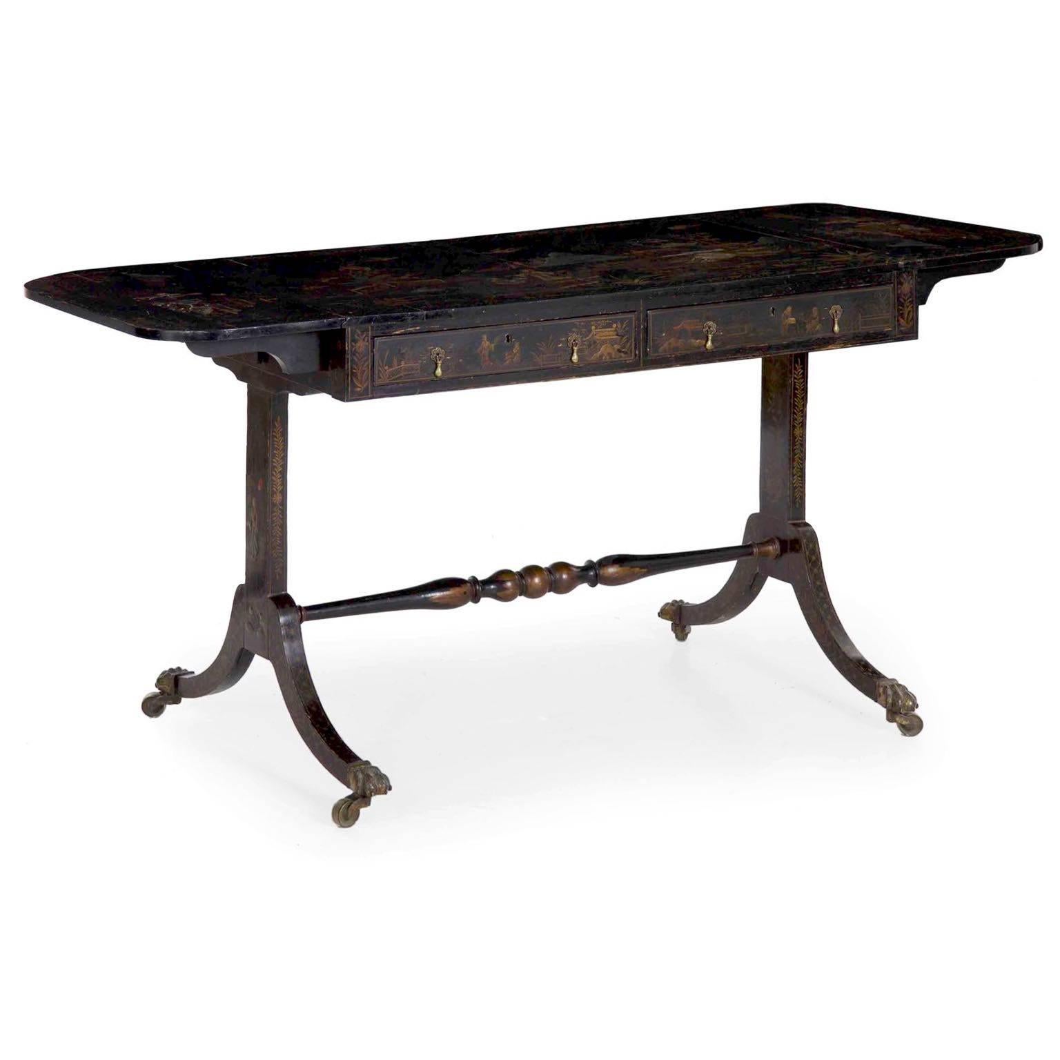 A finely decorated sofa table of the Regency period, it has been beautifully embossed with an ebonized and lacquered chinoiserie display. Reflecting a passion for the Orient during the early 19th century, the table shows rich scenes of figures by