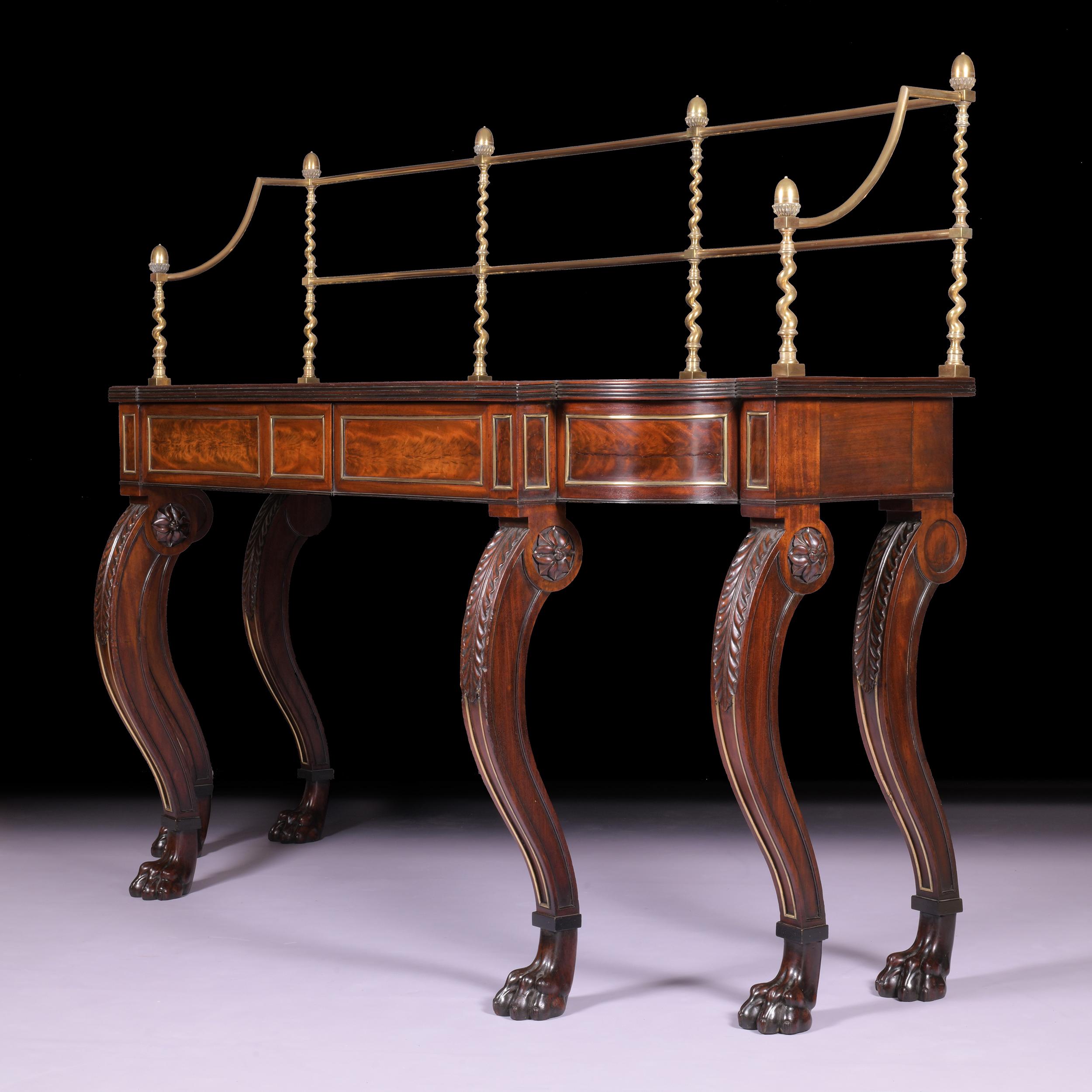An exceptional and unusual early Regency mahogany and ebony banded serving / console table, with brass gallery back above a rectangular top with breakfront reeded edge and bowed ends, resting on a frieze with two disguised central drawers with
