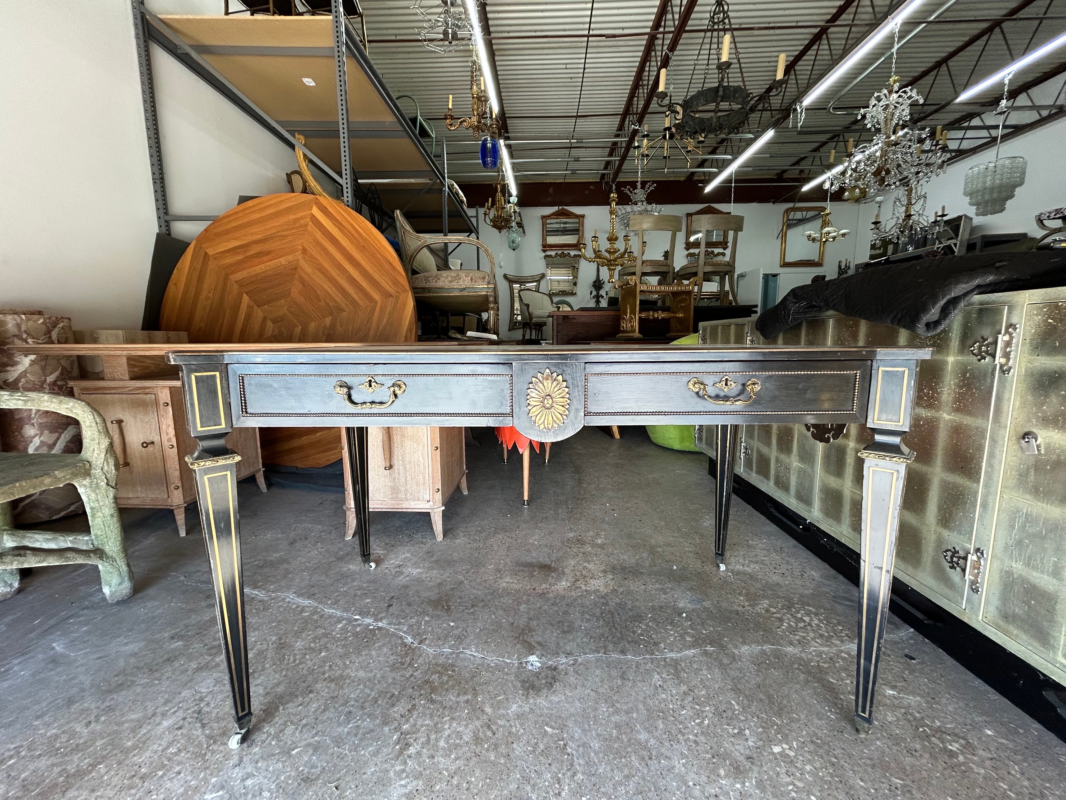 19th Century English Regency Ebonized Desk.
Offered is an unusually shaped early 19th century period English Regency ebonized desk with two drawers which is finished on both sides. Our stunning desk (similar in style to French Louis XVI) has