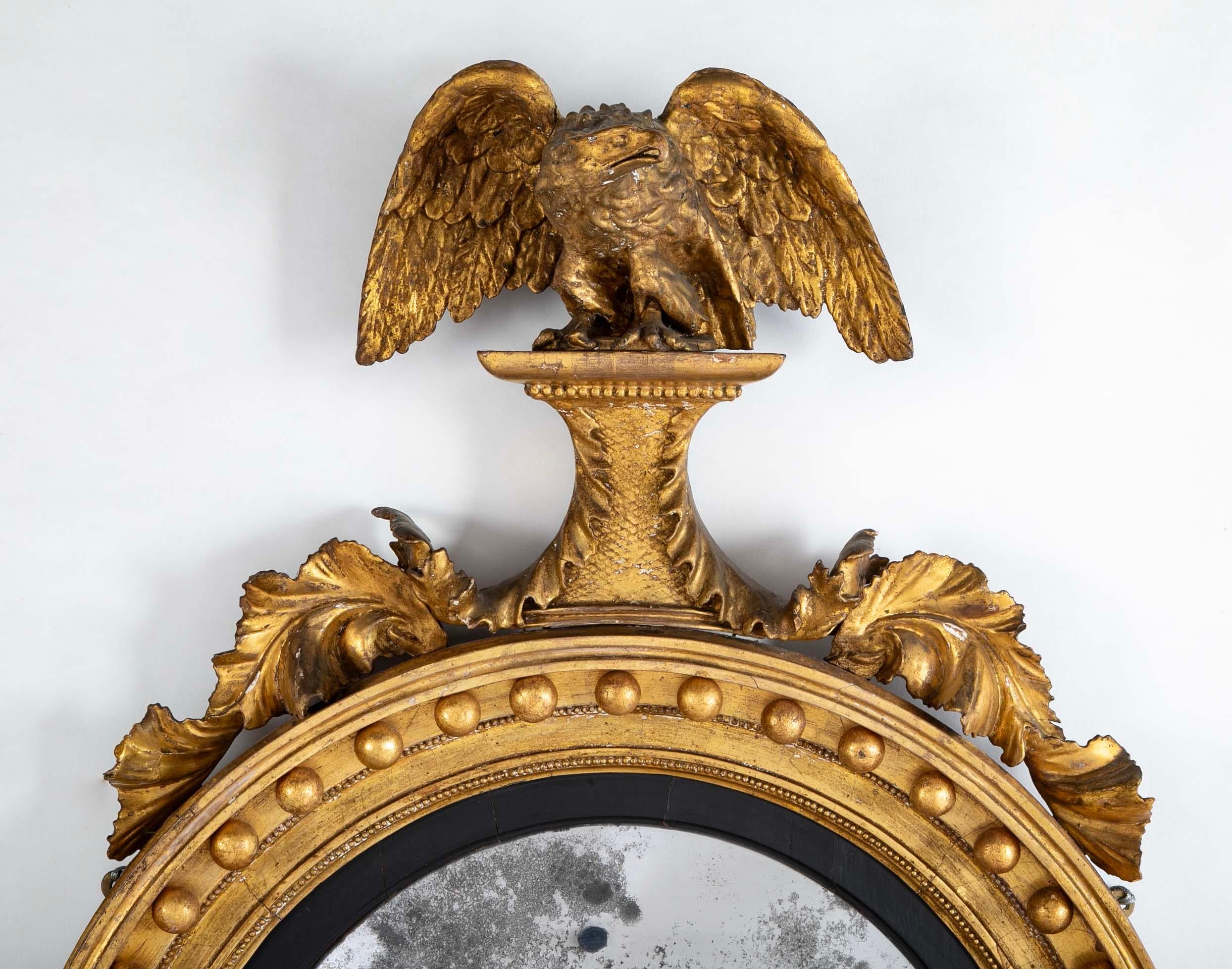 Glass 19th Century English Regency Gilt Wood Convex Mirror with Carved Eagle For Sale