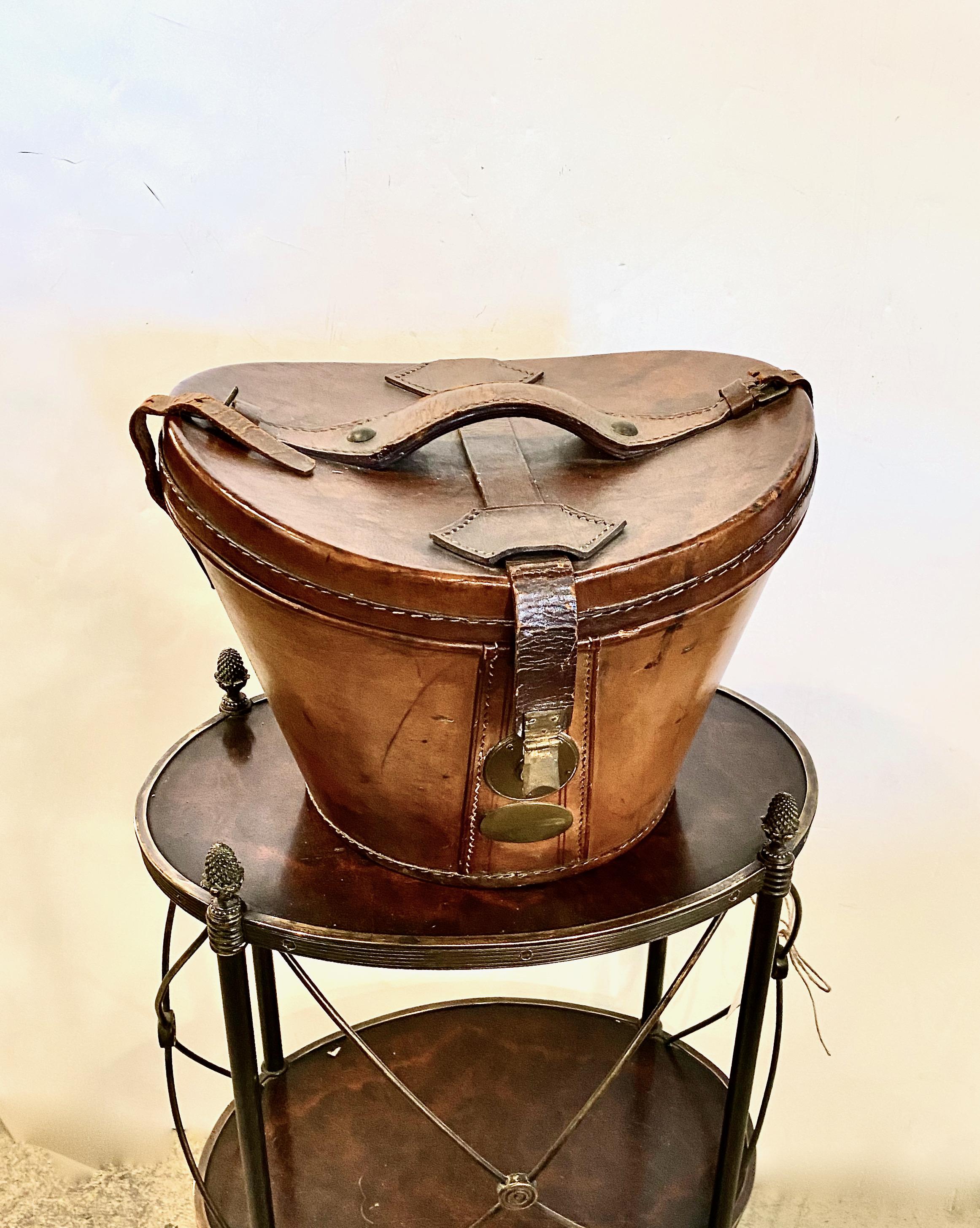 This is a good example of an early-19th century English Regency leather hat box. The box is in very good condition considering its nearly 200 years. The leather straps are dry and the body of the box would benefit from conditioning. The interior of