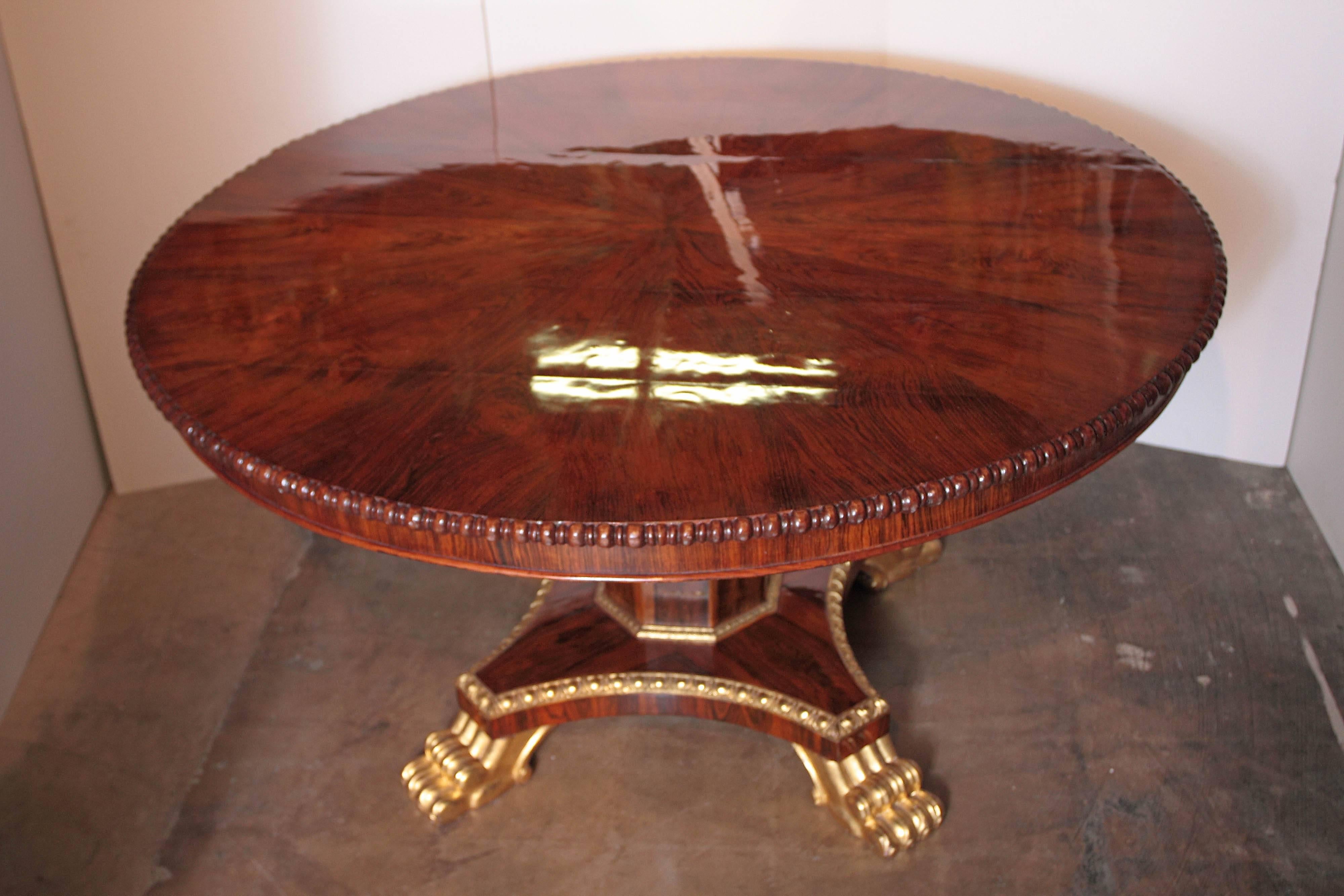 Beautiful 19th century English mahogany and rosewood, parcel-gilt pedestal base and pawed feet centre hall table.