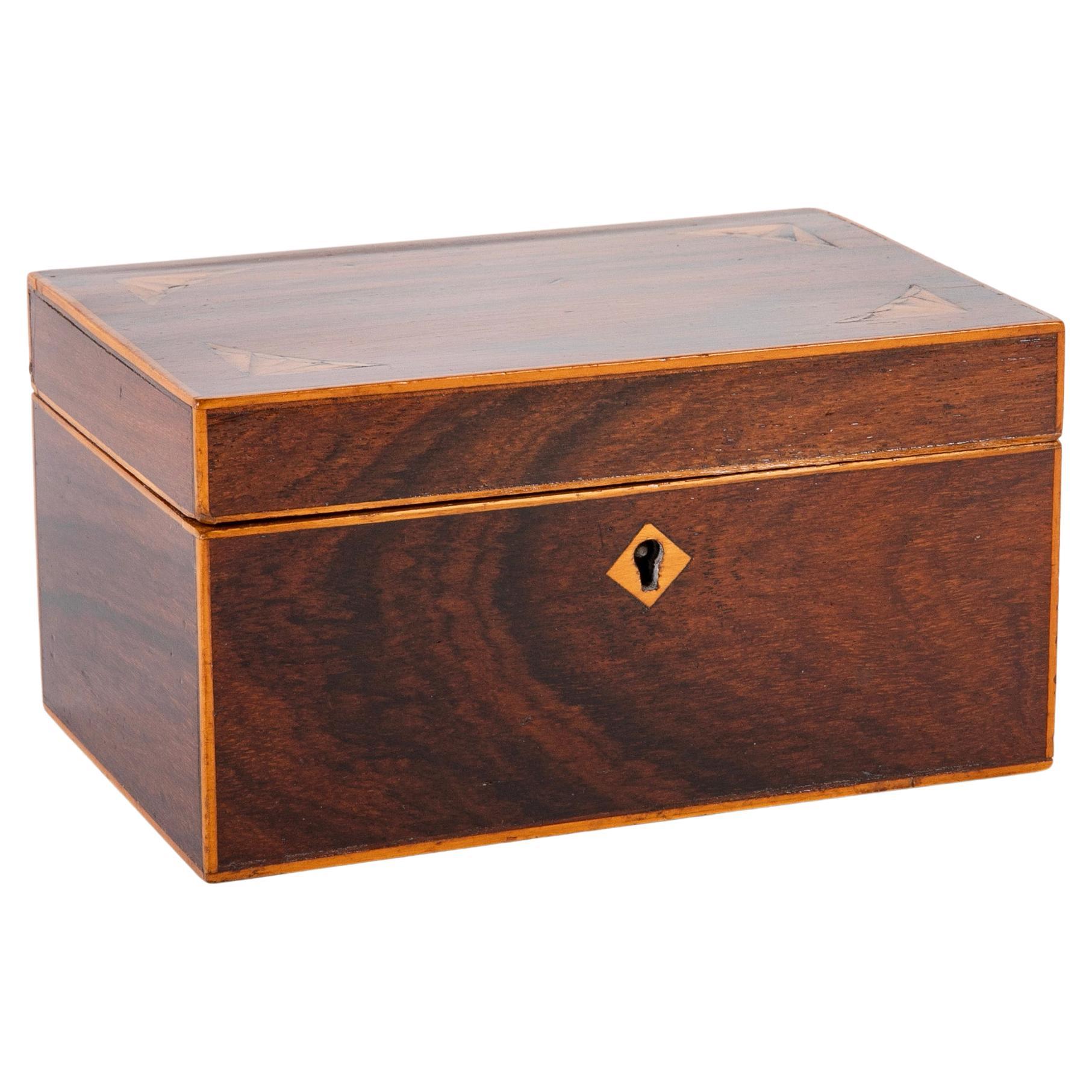 English Regency mahogany box with satinwood inlay. The four corners of the top are inlaid with lovely triangular scalloped decoration. All the border molding are also satinwood inlay as well as the diamond shaped keyhole escutcheon. A sweet little