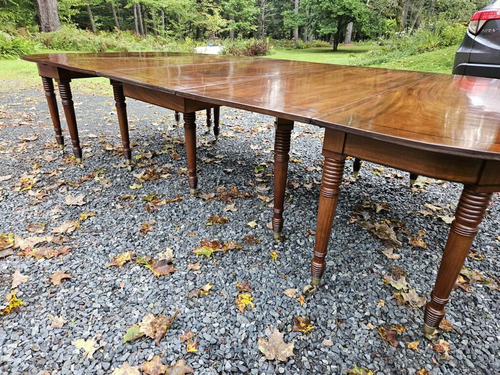 Early 19th Century English Regency Period Dining Table.  Three sections with two original leaves.  Extremely well-figured solid mahogany with unusual and original ebony string inlay.

Provenance: a Greenwich, CT Collector