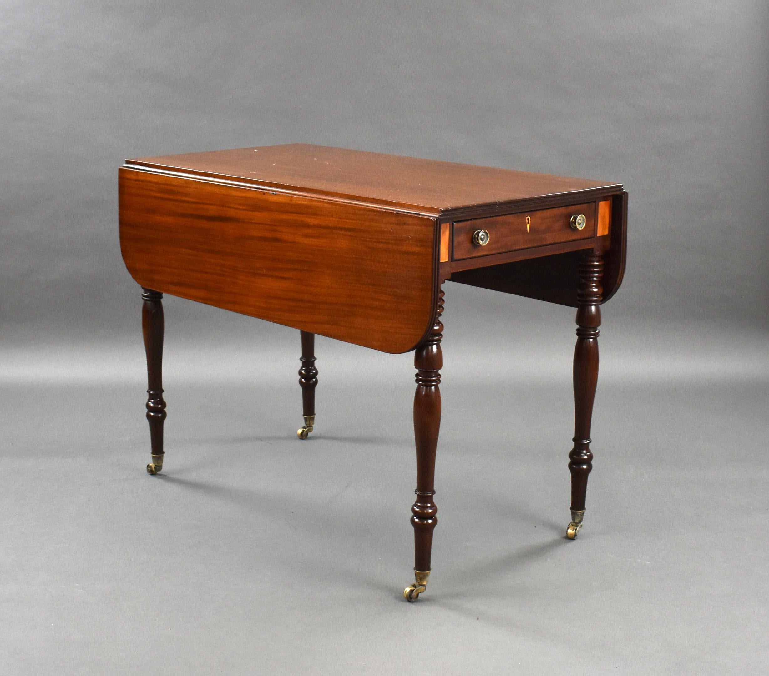For sale is a good quality Regency mahogany pembroke table, having two drop leaves above a single drawer to the front and a faux drawer on the opposing side. The table stands on elegant turned legs raised on original brass castors. This piece is in