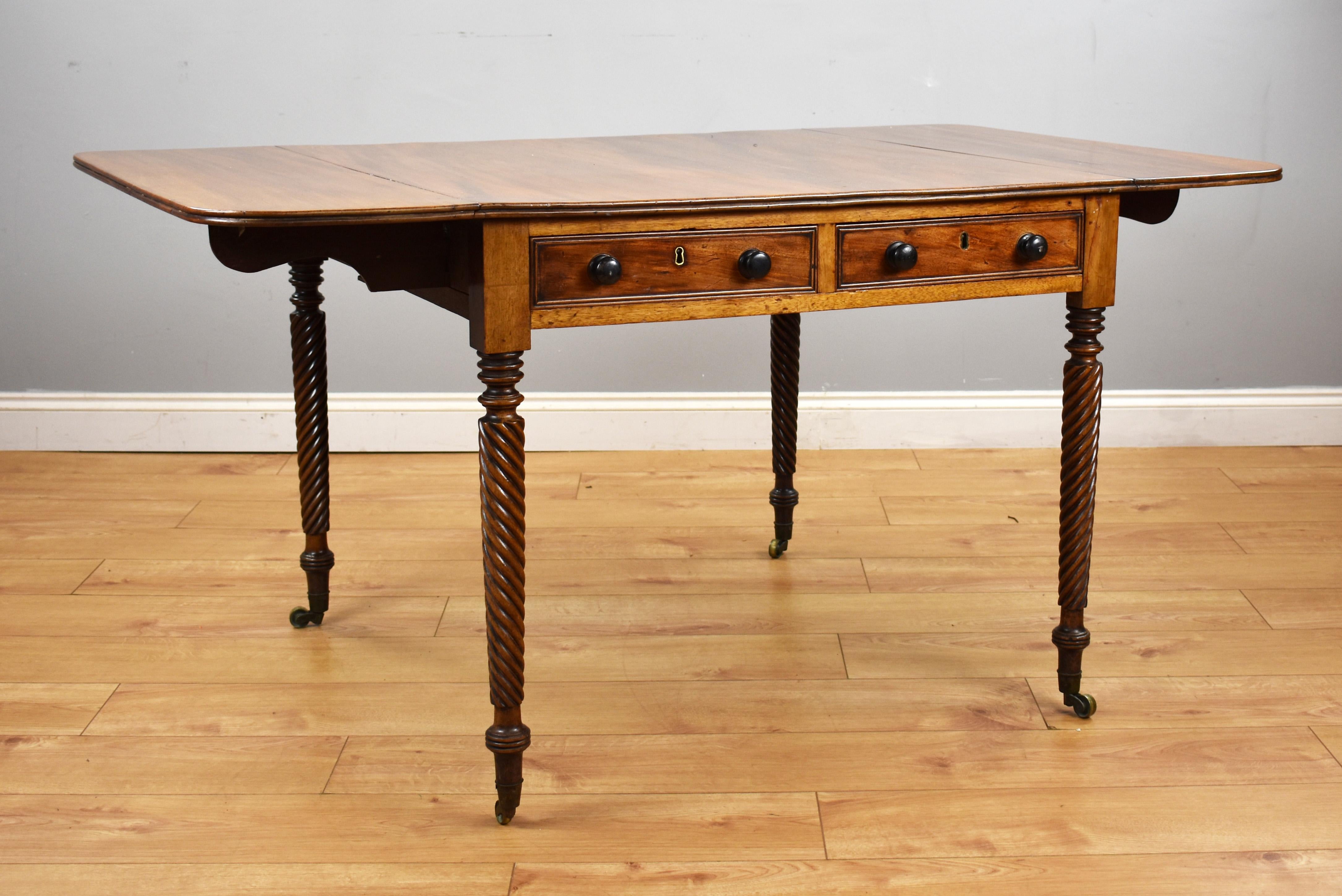For sale is a Regency mahogany drop-leaf table, having two drawers to the front and two faux drawers to the opposing side, raised on superbly turned legs terminating on castors. The table remains in good untouched condition, showing signs of wear