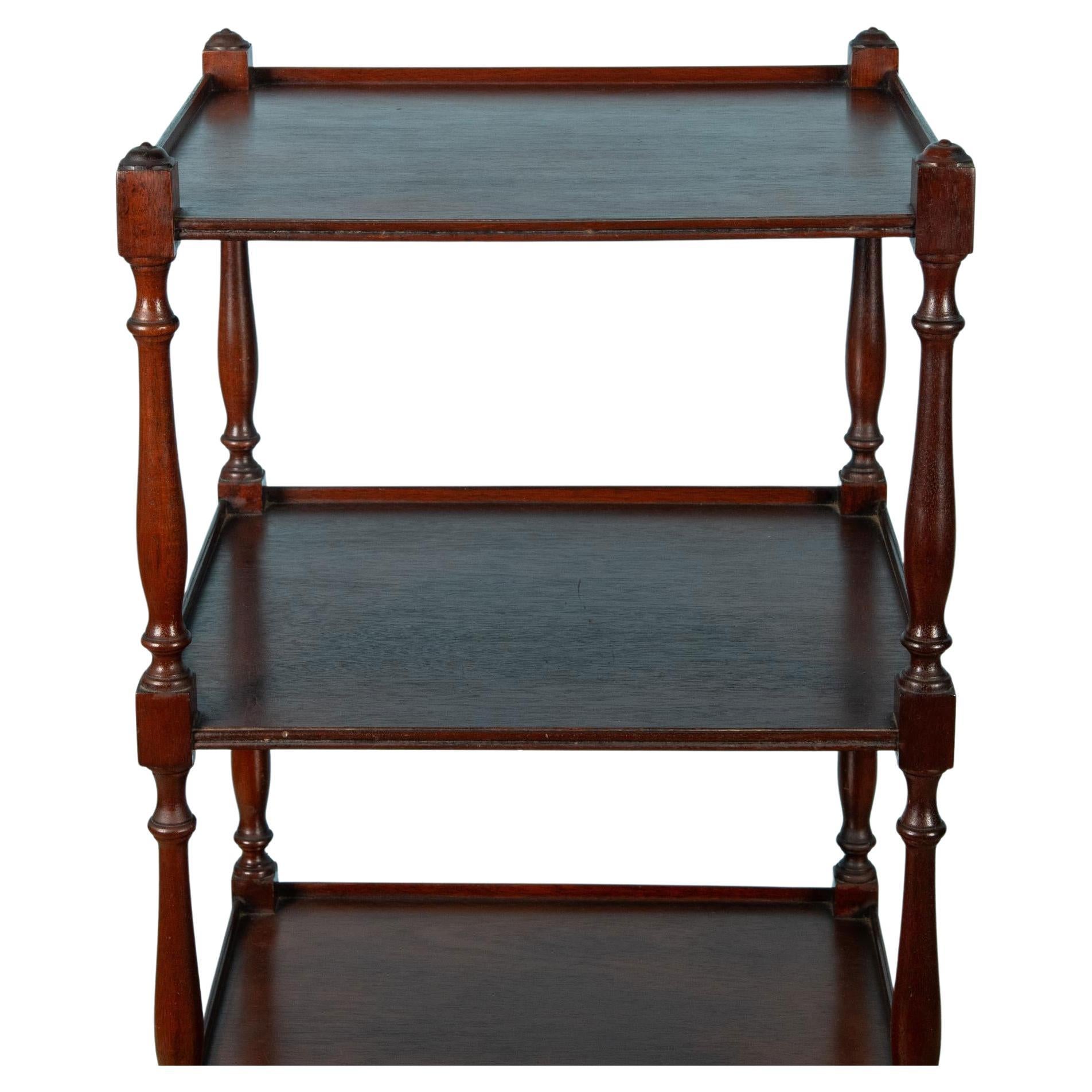 19th Century Square English Mahogany Etagere with brass casters and knobs. Etagere features four horizontal shelves with subtle railings for along the sides for added security, and are ideal for displaying decorative items like books, porcelain, or