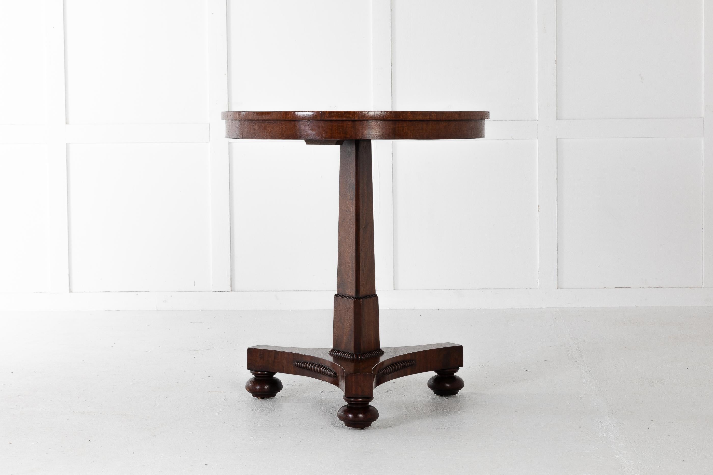Nicely veneered and cross-banded English 19th century small, lamp table on a tripod base, with bun feet and castors.