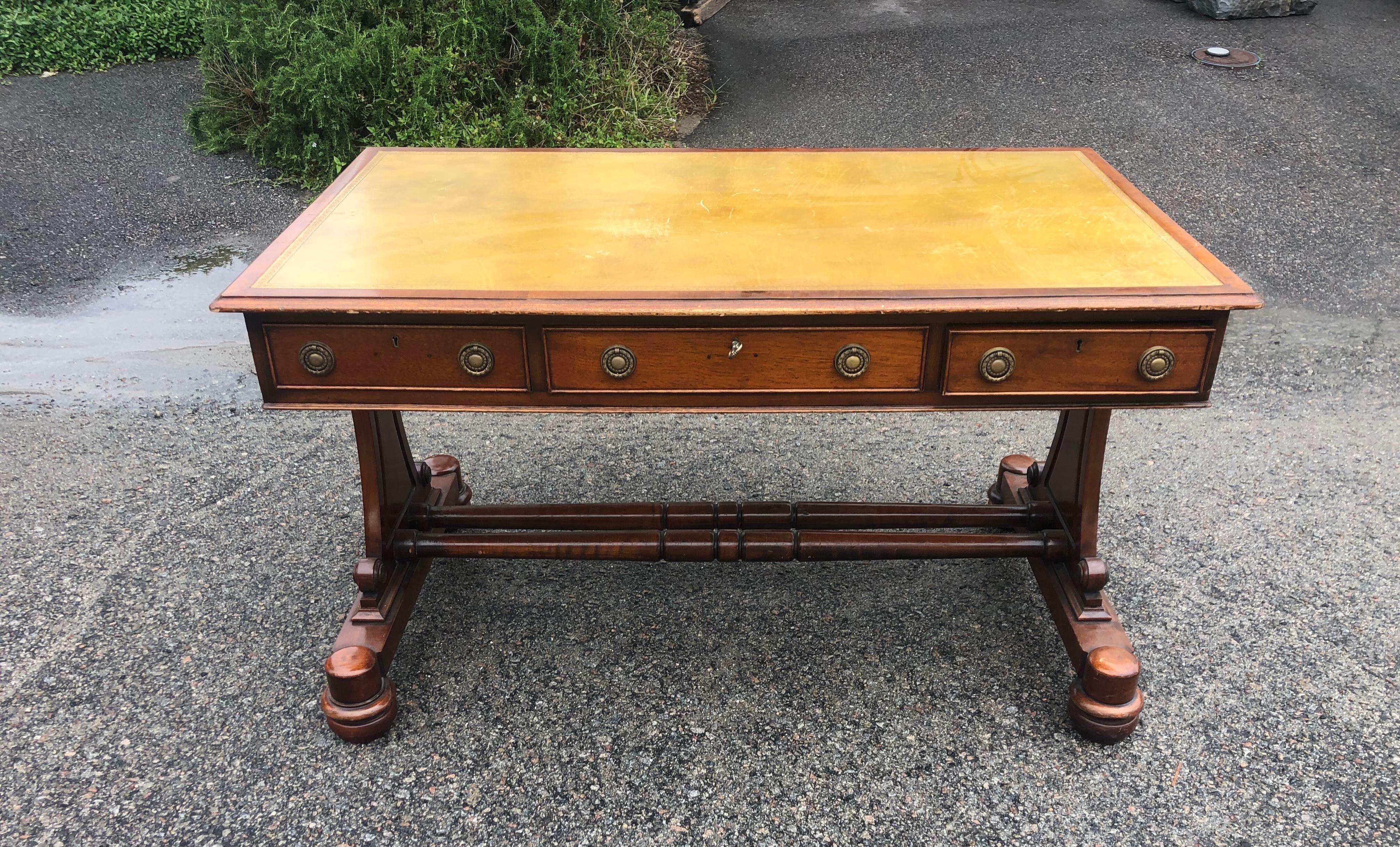 19th century English regency mahogany leather top writing desk. 3 drawers with three matched faux drawers and great olive green tooled leather top.