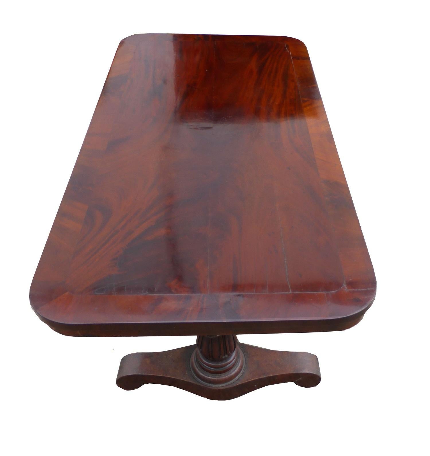 For sale is a good quality Regency flame mahogany centre table/ window table. The top of the table has a nicely banded edge, surrounding a flame mahogany centre. The table stands on two turned and carved legs, united by a stretcher. This piece is in