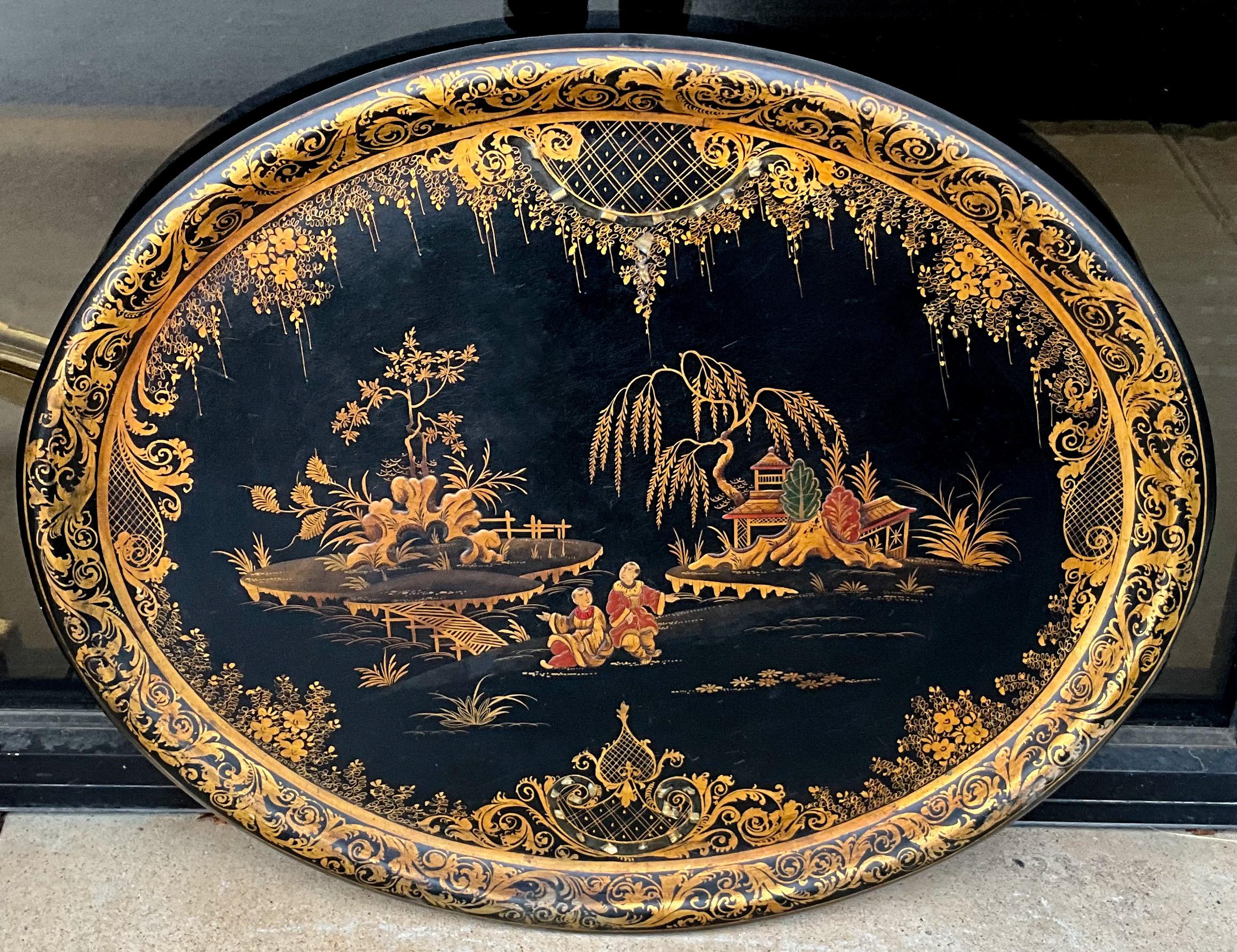This is a 19th century Regency papier-mâché chinoiserie tray. In addition to the lovely pen-work, it has mother of pearl inlay. It is not marked. Lite and general wear.