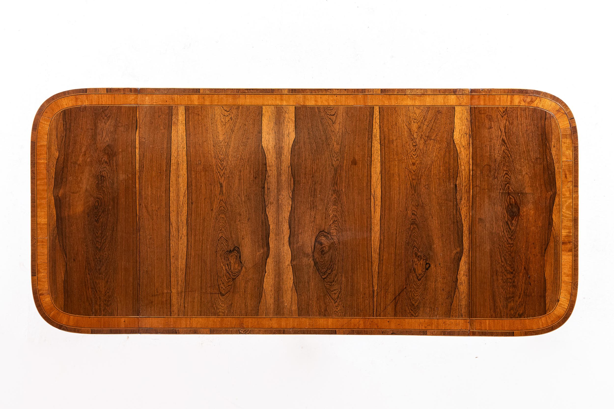 A Small and Very Fine 19th Century English Regency Period Sofa Table in Highly Figured Rosewood.

This lovely table is of a smaller size than most, its proportions are particularly fine. It is extremely well-balanced, the slim end supports and high