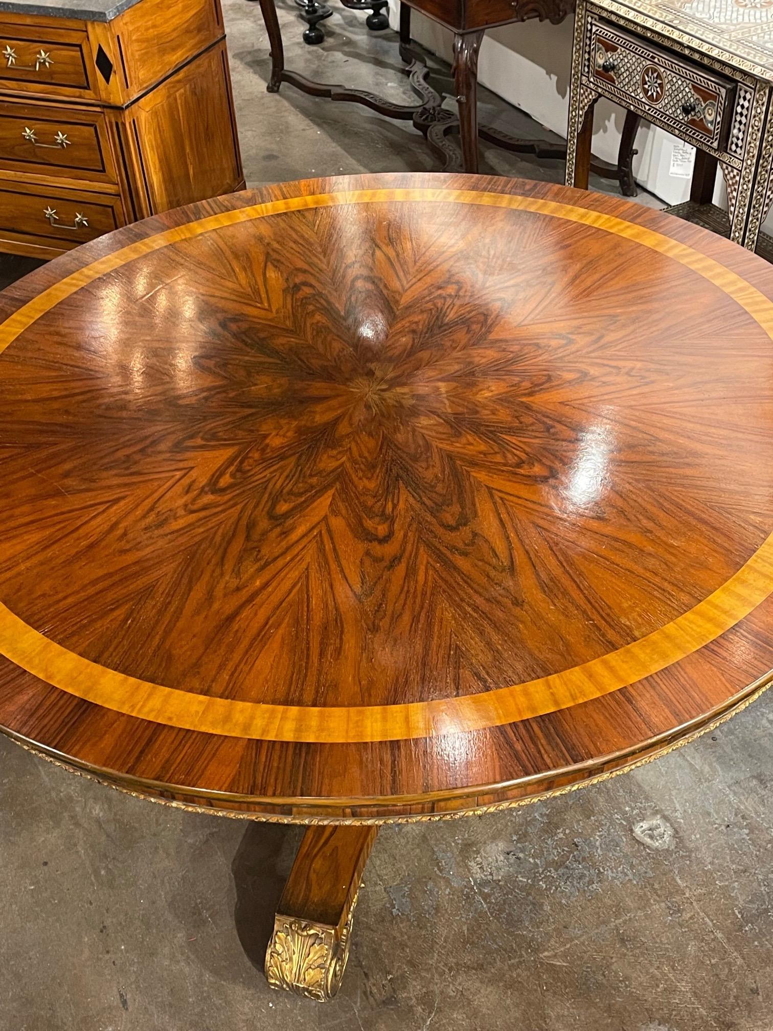 Exquisite 19th century English Regency style black walnut and gilt center table. Beautiful inlaid details along with gorgeous finish on the wood. The piece also has very Fine gilt details. Stunning!!
