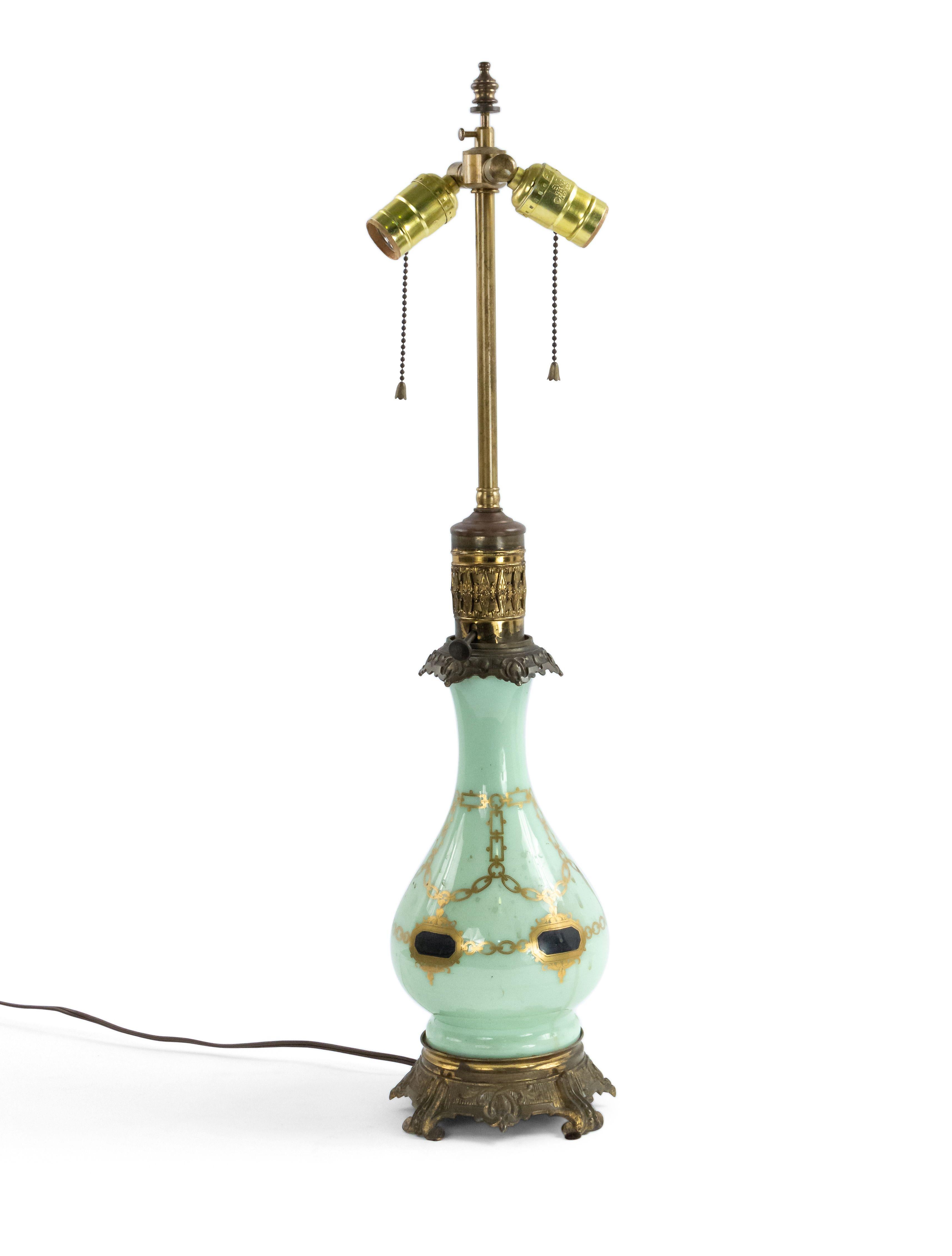 Pair of English Regency style (19th Century) celadon glass table lamps with gold chain design and bronze base. Originally oil lamps now fitted with electricity (PRICED AS Pair).
