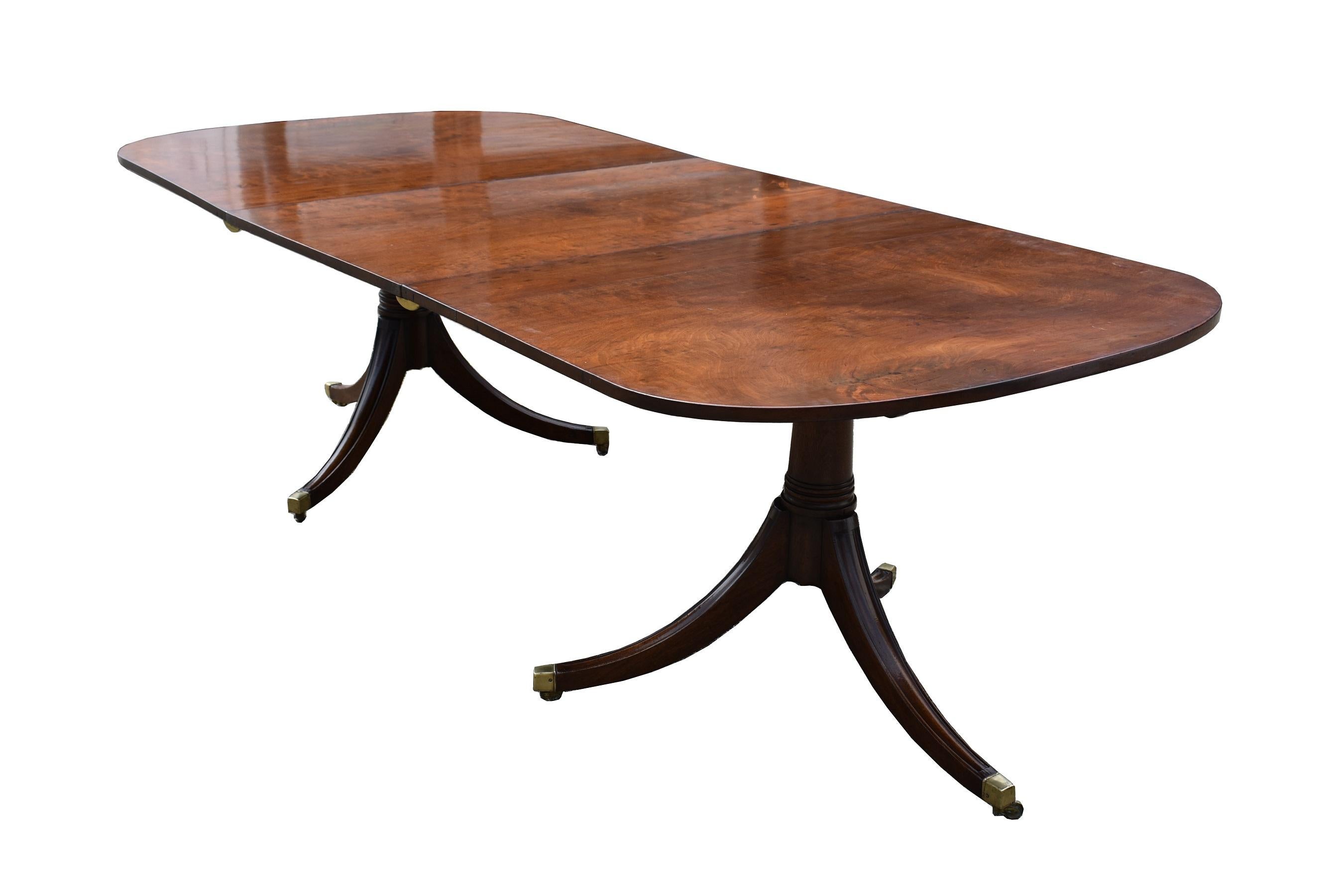 For sale is a good quality 19th century English Regency style solid mahogany pedestal dining table. Having two D-Ends, with a large additional leaf, each table top is made from beautifully figured mahogany. Supported by a two pillar base, each