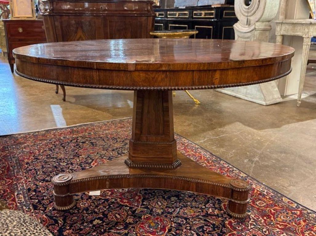 The product is a stunning 19th Century English Regency Style Rosewood Center Table. With it's gorgeous wood finish and clean lines this table adds a touch of elegance to any room. A timeless piece that exudes sophistication and style. Perfect for