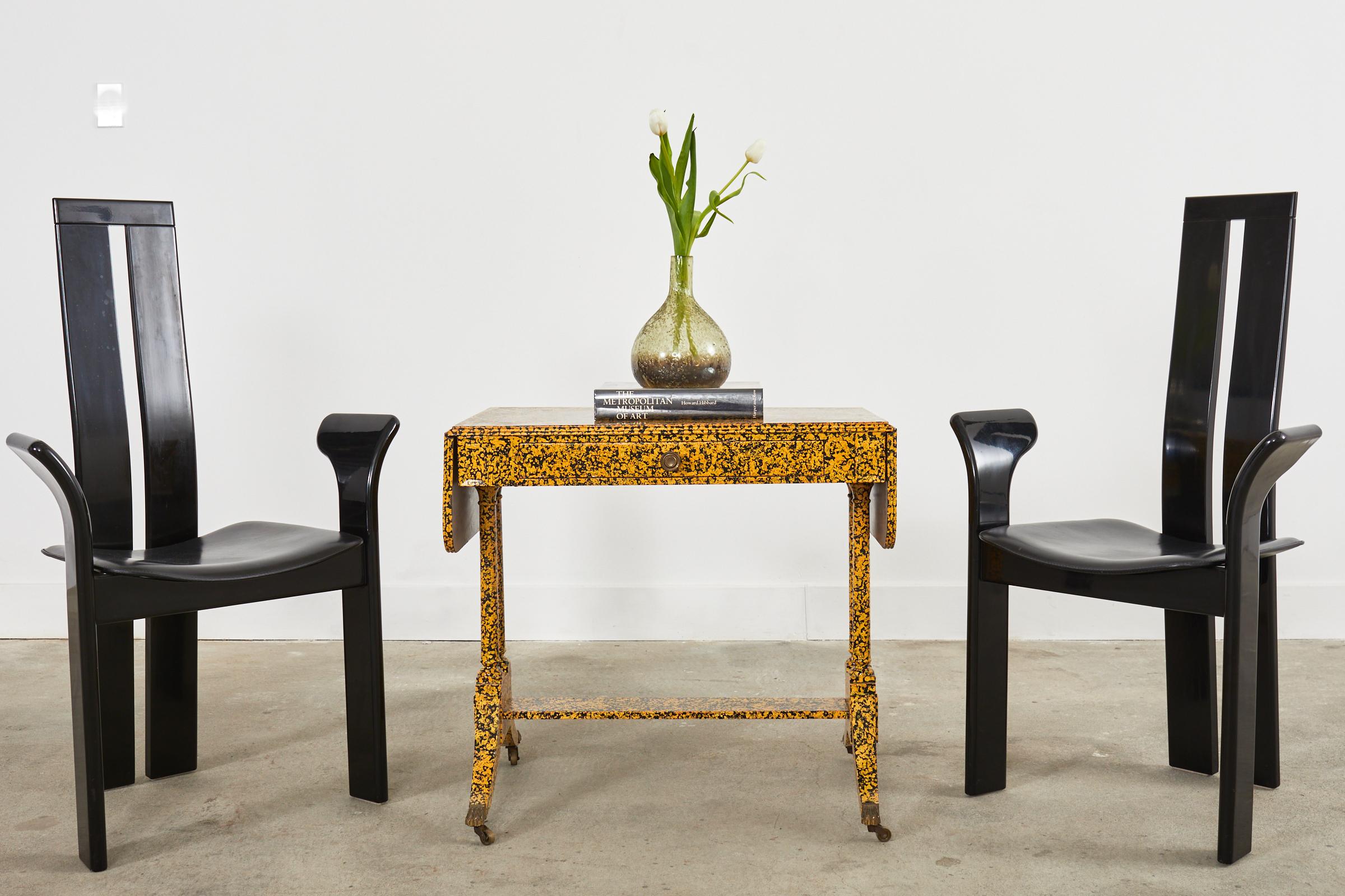 Whimsical late 19th century English mahogany drop-leaf writing table featuring a speckled lacquer finish by artist Ira Yeager (1933-2022 American). The elegant table is crafted in the regency taste with a drop-leaf case fronted by a small storage