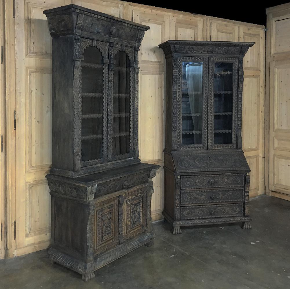 This exquisite 19th century English Renaissance bookcase provides display and storage in Old World style! Hand-carved all over from solid old-growth oak, it features spacious display with shelving fronted with complementary carvings flanked by